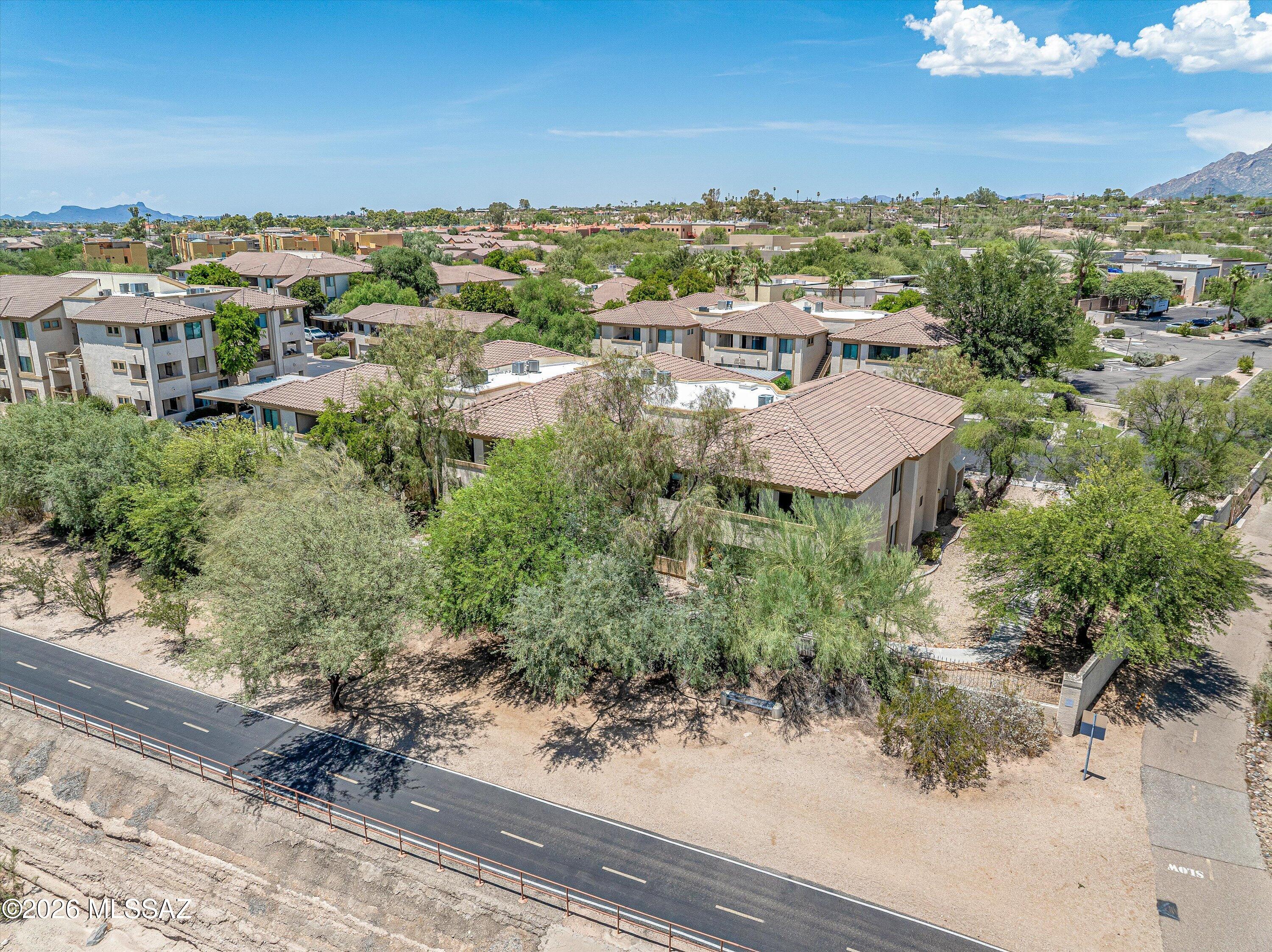 Experience elevated desert living in this spacious ground floor corner unit condo overlooking the Rillito Riverwalk in the gated community of Rio Del Sol.  This private Northern Tucson property features an open split bedroom layout with an abundance of natural light, eat-in kitchen with stainless steel appliances, cozy electric fireplace, expansive covered patio with storage closet, luxury water proof vinyl & tile flooring, washer / dryer included, primary suite with recently installed zero entry walk-in shower and roomy closet and resort style HOA amenities.  The community of Rio Del Sol / Villas At Hacienda Del Sol include two pools & spas, clubhouse with gym, ramadas with BBQ grills and direct access to the Loop, providing easy access to hiking, biking and nearby restaurants / shopping.