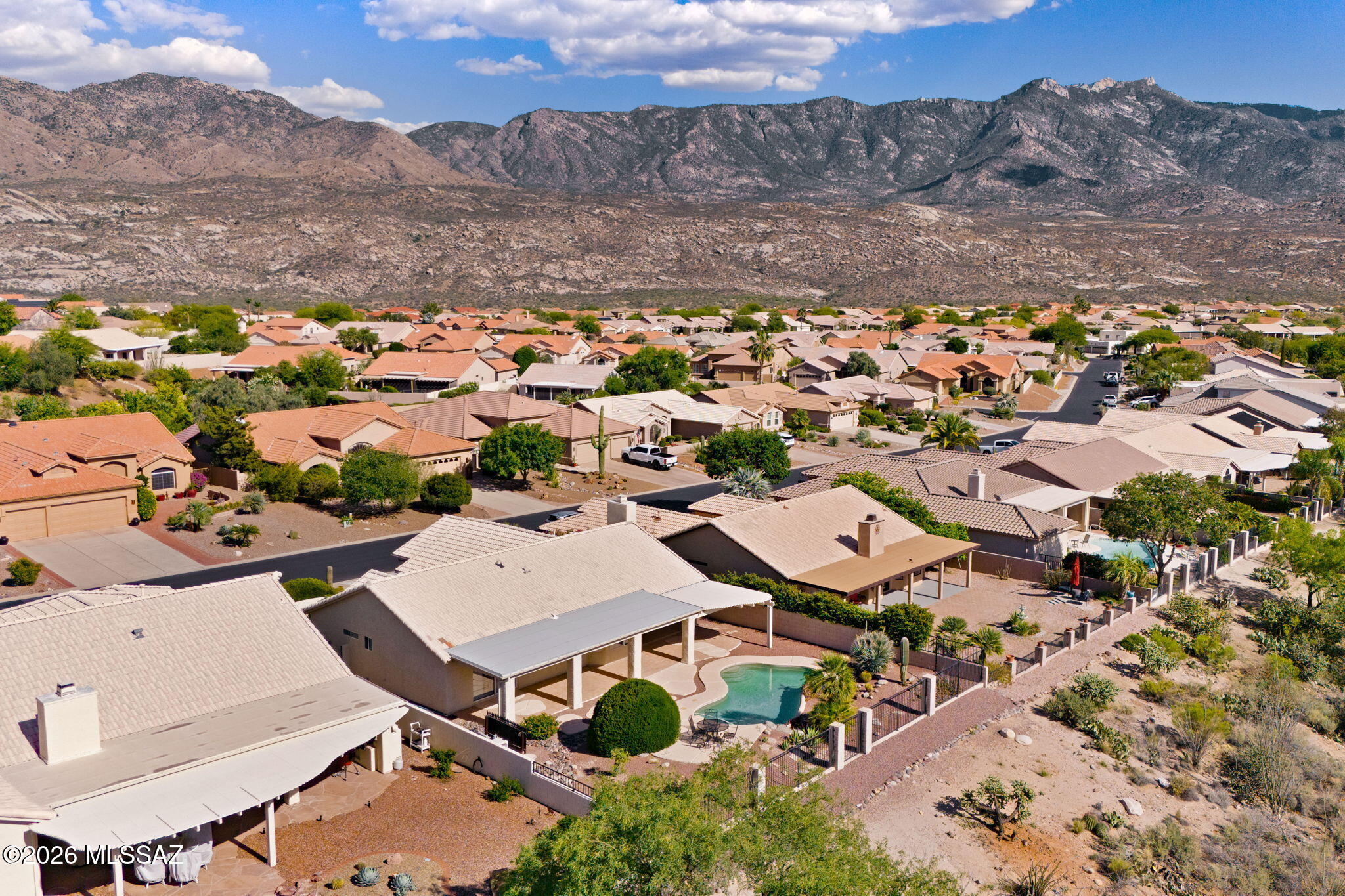 Seller to entertain/counter offers from $425k-$450k. Welcome to Rock Crest Drive in the Highly Desirable SaddleBrooke 55+ Community! This delightful, move-in-ready home is ready to become your new residence, located north of Tucson. This active adult community offers a resort-style lifestyle with golf course views and panoramic Catalina Mountain views. This one-bedroom home offers 1,422 sq ft of living space, including a den (a possible second bedroom) and two upgraded bathrooms, making it perfect for downsizing, a vacation home or year-round living. The Sonora floor plan is exactly what you are looking for. The large great room is ideal for hosting or relaxing while enjoying the fireplace on chilly Tucson nights. The open plan includes a fully functional kitchen with ample counter space, an electric range, plenty of quality cabinetry and a dining/breakfast nook area. Just off the entry and great room is the den, perfect for a home office or craft room. A Murphy bed, perfect for guests, is hidden behind the concertina doors and offers a mountain view from the front of the home. 
The split floor plan ensures privacy. The Owner's Suite is located at the rear of the home with a sliding door to the back patio, pool area and extended patio. The luxurious ensuite features a double vanity, granite countertop, heated floor, an oversized walk-in shower, and a walk-in closet.
The elevated home is positioned to maximize the view, offering unobstructed sights of the Golf Course, the Catalina Mountains and the ever-changing desert with no rear neighbors.  Enjoy your own private sanctuary as you relax on the extended covered patio, complete with ceiling fans. Cool off in the sparkling pool, which features custom landscaping, a cool deck and elevated seating overlooking the golf course. An aluminum ramada is also attached to the patio; it includes a built-in gas BBQ and more entertaining space.
The SaddleBrooke community offers extensive amenities and over 100 social clubs. Residents enjoy golf courses, multiple clubhouses, fitness centers, swimming pools, tennis/pickleball courts, and restaurants. along with a safe, quiet environment,  24/7 security and convenient access to nearby shopping, golf, and hiking. Sitting at a 3,500-foot elevation makes it slightly cooler than Tucson or Phoenix.
Other great features include the extended garage with epoxy flooring and storage, solar tubes, plantation shutters, built in cabinets provide more storage, flagstone pavers, manicured landscaping and so much more. Are you ready to move to SaddleBrooke? Make an appointment to see this property today!
