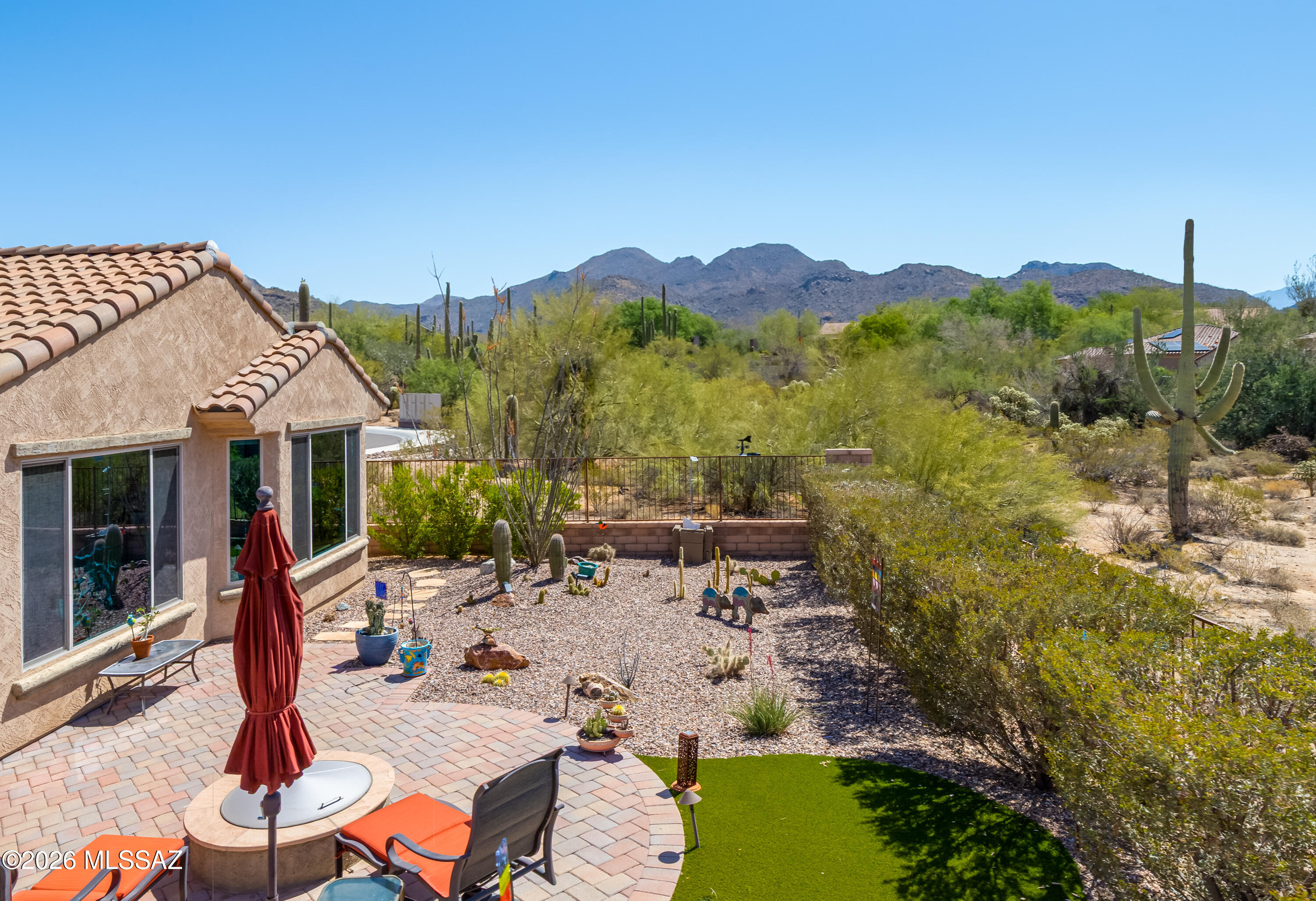 Welcome to this delightful Sanctuary floor plan offering 1,833 sq ft, with two bedrooms, two baths, and a versatile den, nestled on a premium cul-de-sac lot with MOUNTAIN VIEWS. A gated patio invites you into a bright and airy home showcasing an open-concept design that seamlessly connects the all-capturing natural desert from outside. The kitchen is anchored by grey cabinetry, quartz countertops, stainless steel appliances, an induction cooktop with a  custom subway tiled backsplash offering style and functionality. The primary suite features a bay window, dual vanities, step-in shower and a walk-in closet. A guest bedroom and nearby full bath provides comfort for visitors, while the den offers another flexible space.  Oversized two-car garage features epoxy coated flooring.