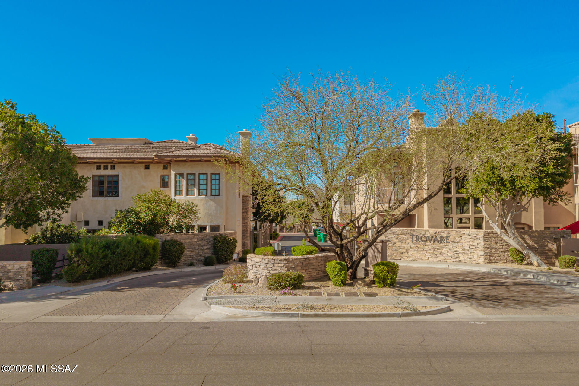 Experience the pinnacle of sophisticated living within Trovare, an exclusive gated enclave nestled in the prestigious Biltmore/Arcadia corridor. This isn't just a home; it's a sanctuary designed for those who refuse to compromise on style or location. From the moment you step through the double front doors, you are enveloped in an atmosphere of refined luxury in this meticulously maintained residence. A sweeping grand staircase anchors the entryway, while expansive windows flood the space with natural light & frame serene views of your private surroundings. There is a den/formal dining room just off of the foyer that offers a flexible space to fit your needs. The gourmet kitchen is a masterpiece of form & function, curated for both the casual host & the serious chef. Kitchen features include professional grade gas range & integrated wall oven; Designer Finishes such as sleek granite countertops & a spacious walk-in pantry; Plus extras like a coffee station to get your morning started off right & a wine fridge for your relaxing evenings.

This gorgeous home features a new roof maintained by H.O.A. & a new HVAC, so all of your big ticket items are already taken care of for you!

Uniquely designed for flexibility & privacy, this stunning residence boasts 3 generously sized bedrooms that all feature their own full en-suite bathroom. One is located on the main (ground) level & two more are upstairs. The downstairs suite and secondary upstairs suite are perfect for guests or multi-generational living. The main second-floor primary retreat is a true escape featuring elegant French doors that open to two private balconies. The spa-like bathroom offers an enormous dual vanity, a deep soaking tub, & a glass-enclosed walk-in shower all complemented by expansive custom closets.

The upper level continues to impress with a versatile den that's as large as a bedroom, elevated with custom built-ins (perfect for a home office). The massive secondary bedroom is complete with its own private en-suite bathroom, custom built-in desk & bookshelves, a spacious closet plus an additional bonus walk-in closet. A convenient laundry suite with built-in cabinetry & utility sink completes this impressive upper level.

Indoor-outdoor living is seamless here. Whether you are sipping espresso on one of the three balconies or hosting a cocktail hour in the lush wrap-around courtyard, the exterior spaces offer a peaceful retreat from the city buzz.

A two-car garage & private driveway accommodates all of your immediate parking needs. There is plenty of uncovered parking throughout the community & street parking just outside the gates for your guests. The garage features a new garage door & EV charger for electric vehicles.

Location is everything. Enjoy unparalleled access to the best Phoenix has to offer. You are less than a mile from:
Biltmore Fashion Park- World-class shopping and upscale boutiques.
Culinary Excellence: The city's most celebrated dining destinations.
Convenience: Whole Foods & easy access to the 51 Freeway.

At Trovare, you truly can have it all. Come on in and see this rare gem before it's gone!