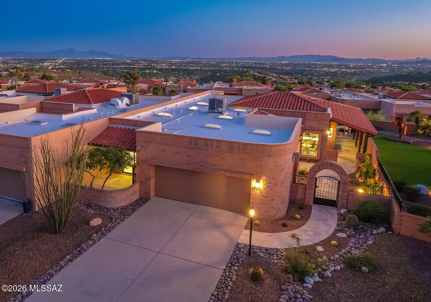 You've reached the Top! At the summit of coveted Fairfield Sunrise East, this stunning Foothills Renovation seamlessly embraces the undeniable Panoramic Views w/ refined & sophisticated daily life. A diligent, thoughtful approach has intentionally provided intimate living spaces that promote comfort and connection. Great Room design concept w/ distinctive, uniquely modern Fireplace treatment while 16-foot Sliding Glass Doors ease transition to sublime outdoor moments. Travertine rear patios demand a visit & ample time to enjoy the glowing city lights. Elegant contemporary kitchen pops w/ sleek Italian cabinetry, premium Bertazzoni appliances & Marble Counters. Sumptuous Master Suite offers inspiring vistas & next-level Bathroom/Closet design. 2nd Bedroom w/ private patio plus spacious Den.
