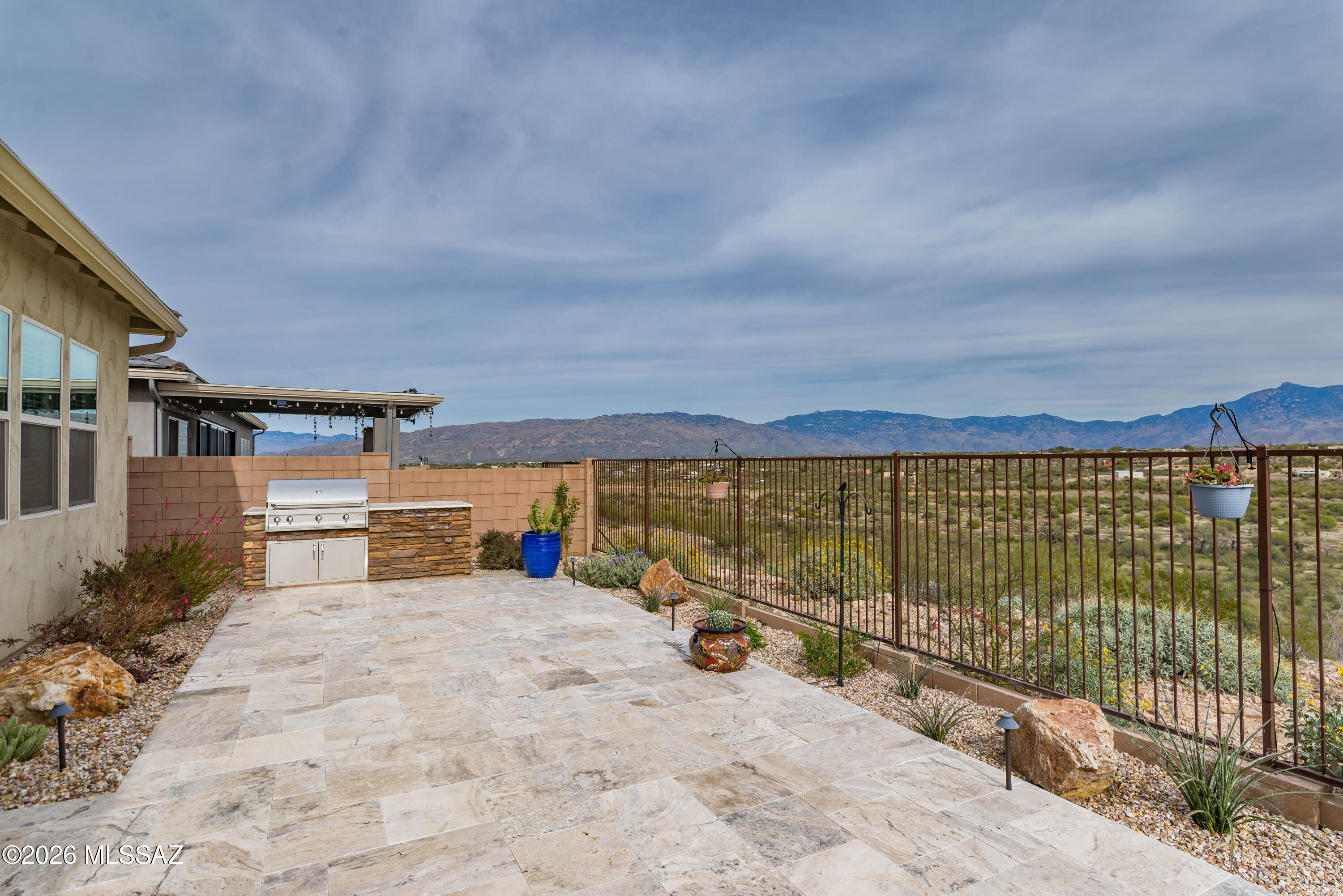 Sweeping Mountain Views highlight this Better Than New home in the gated Vistas at Rincon Knolls Community. Beautifully upgraded home features Great Room Floorplan, Split Bedrooms, plus a flexible Teen/Media Room. The Gourmet Kitchen includes an Impressive T-shaped Island, Gas Cooktop, Gorgeous Cabinetry and Walk-In Pantry. The spacious Primary Suite takes in Amazing Mtn Views and lots of Natural Light. Enjoy the Lux Feel Ensuite Bath with Separate Vanities, oversized Walk-In Shower plus Lge Walk-In Closet. The 12' Centered Sliders in Great Room lead out to a Stunning Backyard, a real Showstopper! With Rincon Mountain views, No Rear Neighbors! Love the Gorgeous Travertine Patio, Built-In BBQ, Motorized Sun Screen and Custom Installed Hot Tub! This IS AZ Indoor/Outdoor living AT IT'S BEST!
