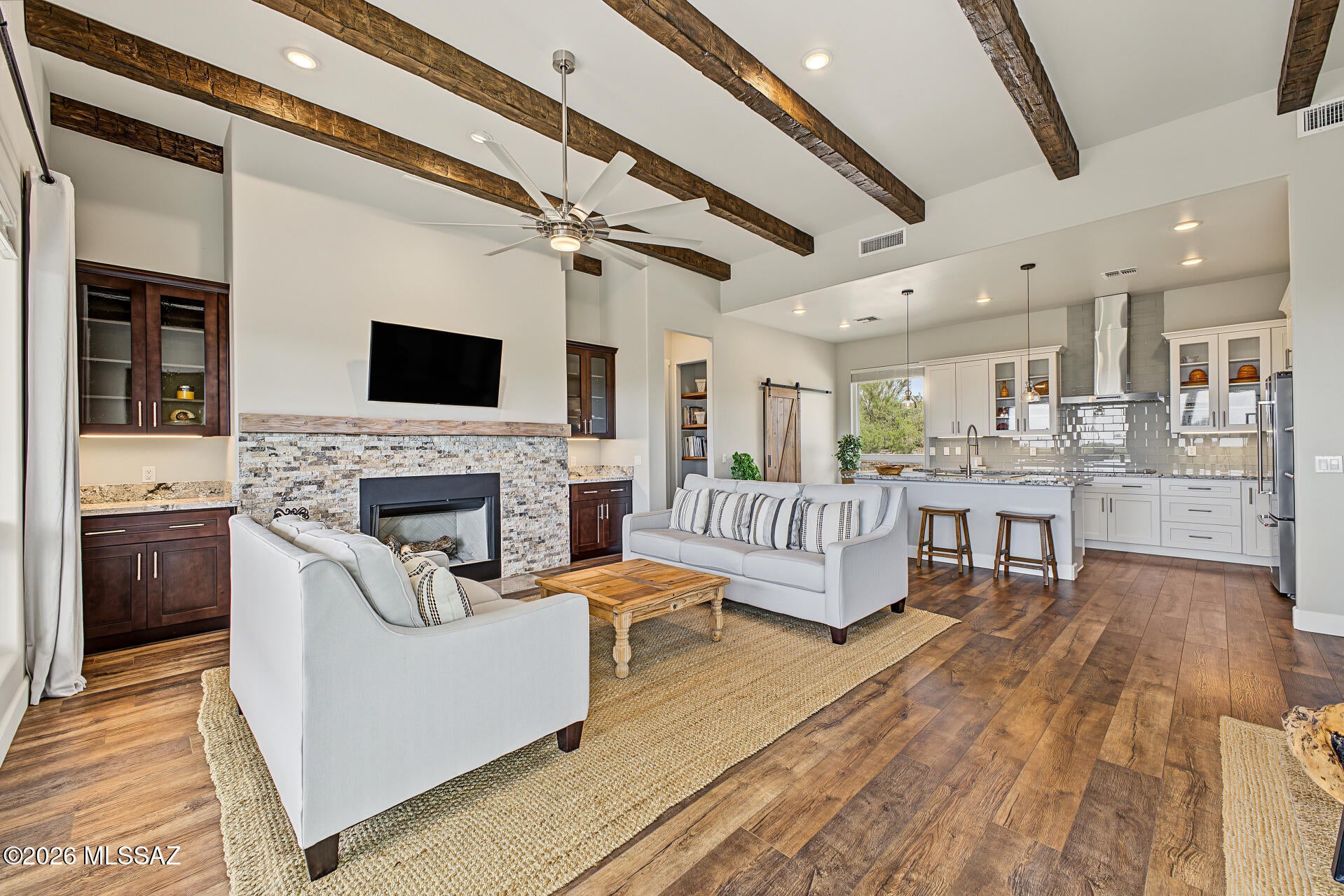 Peaceful Country Living | 5 Acres | Custom Home | Stunning Views

Enjoy privacy, open space, and breathtaking long-distance views from this nearly new, quality-built custom home situated on 5 peaceful acres. Large windows bring the surrounding landscape into the home, while thoughtful design and high-quality finishes create a comfortable and inviting living space.

The 3-bedroom, 2-bath home features a spacious great room with a wood-burning fireplace, impressive 12-foot beamed ceilings, 10-foot ceilings throughout much of the home, and 8-foot doors. The well-appointed kitchen includes KitchenAid Pro appliances and granite countertops, with numerous custom touches throughout.

The primary bath offers relaxing massage shower panels, while durable, water- and scratch-resistant laminate Provides the look of real wood with easy-care convenience. A metal roof adds durability, and both front and back porches provide inviting spaces to enjoy the peaceful surroundings and expansive views.

Located just 15 minutes from shopping and approximately 30 minutes from Oro Valley, this property offers the privacy and tranquility of country living without being far from everyday conveniences.

For outdoor enthusiasts, the property borders state land across a well-maintained private dirt road, providing access to endless trails and opportunities to explore the surrounding landscape.

An additional 5-acre parcel immediately to the east is also available for those looking for even more privacy, space, or future possibilities. The additional parcel is zoned R1.25.

If you're looking for a unique custom home with acreage, privacy, beautiful views, and convenient access to town, this property offers an exceptional country-living opportunity.