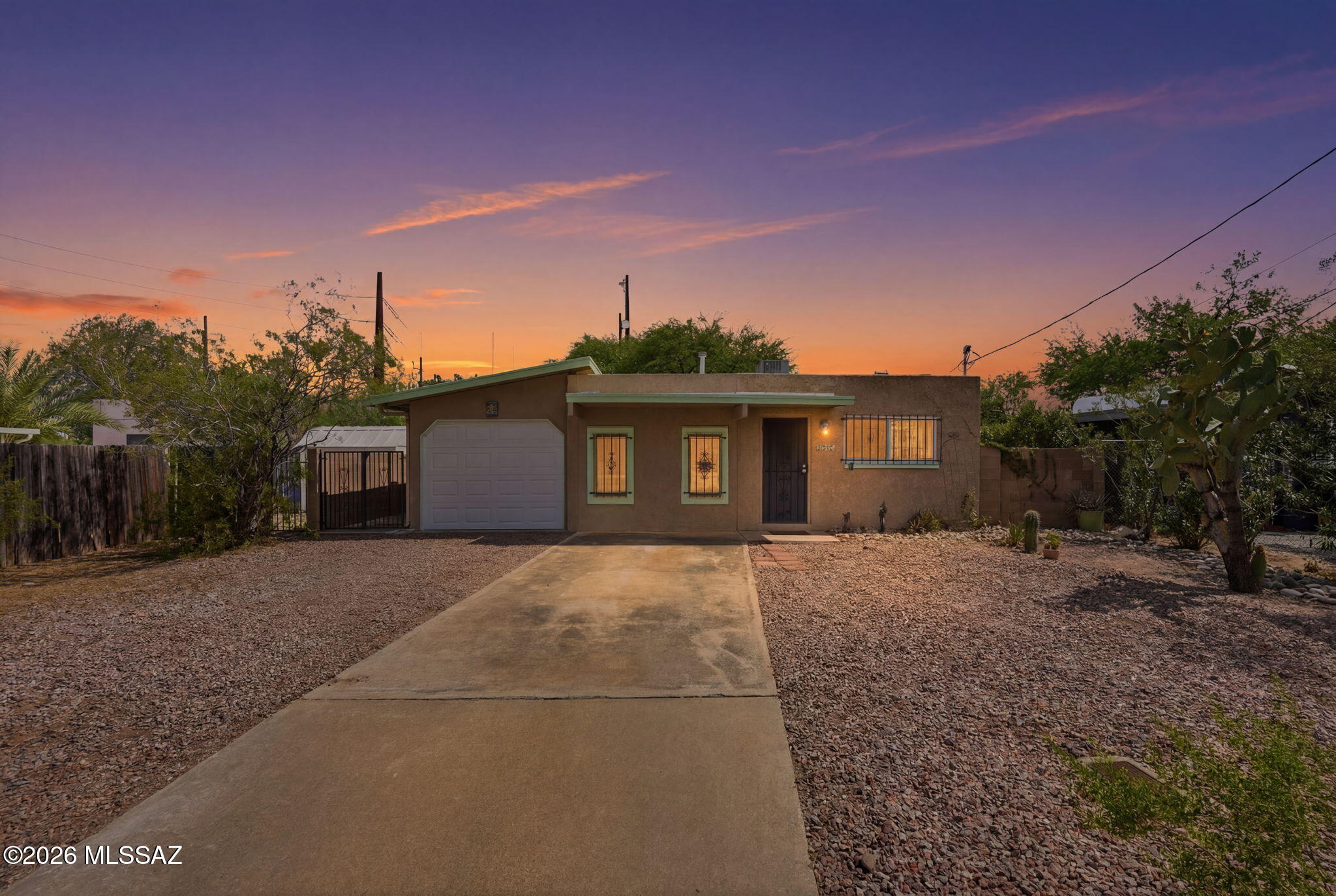 Affordable opportunity for 1,039 SqFt 2 bed/1 full bath 1972 Mid-Century Modern masonry stucco bungalow on .13 acre R-2 lot, attached 312 SqFt garage with storage, the freedom of no HOA in Fruitvale neighborhood located in Central Tucson. Ideal for first time homebuyers, Air-BnB/investment property, seasonal visitors, parents looking to secure student housing and investors alike! Featuring N/S orientation, Catalina mountain front views, private driveway, on and off street parking, single story, no stairs/no steps, secure wrought iron security bars on all windows and custom metal security doors.
Inside buyers will appreciate vintage character and charm with modern amenities, featuring updated energy efficient double pane windows and slider ($12K installed 2022),  recently added gas HVAC in 2022, digital thermostat, textured painted ceilings (no popcorn), skylights, ceiling fans, custom window blinds, tile and luxury plank flooring (no carpet), copper and Pex plumbing, internal laundry room w/ new 2025 washer and dryer included, cozy kitchen with original wood kitchen cabinets, huge walk in pantry storage (could serve as an office), stainless steel island, bar seating, gas stove, white appliance package with new fridge (2024), double metal sink, garbage disposal, adjacent to living room area and slider out to side yard.  
Enjoy tranquil Tucson sunsets under extended covered backyard patio, landscaped finished backyard with always green artificial grass, flower gardens, metal gate access, 200 amp electrical service, metal gutters all surrounded by block privacy walls.
Minutes away from shopping, groceries, fine dining at Culinary Drop Out, Snooze, Kingfisher, Banner Medical, the University of Arizona and TMC. Call to make your appointment to view this value priced home today!