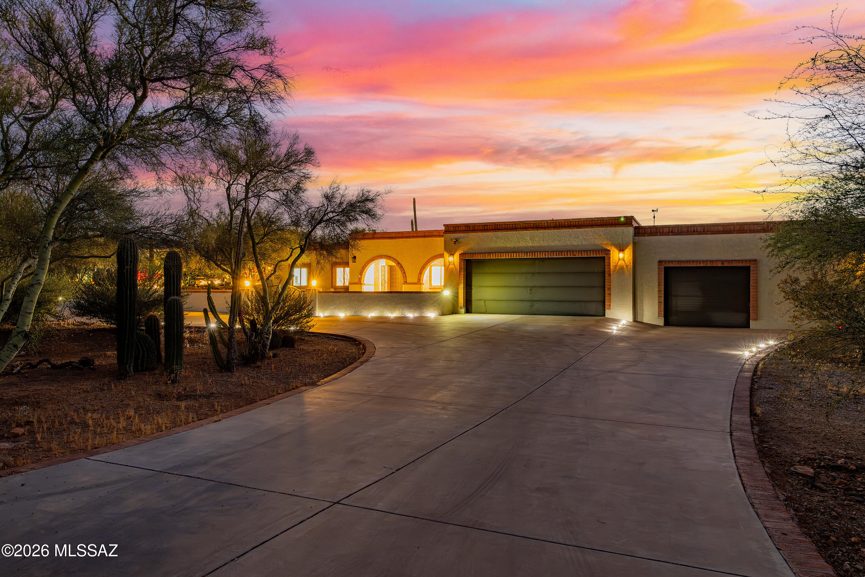 Great west-side property with breathtaking mountain views on over an acre! This 2,495 sq ft, 4-bed, 3-bath home provides generous space for comfortable living and entertaining with a welcoming living room and a spacious family room with a cozy wood-burning fireplace. Formal dining room sits adjacent to the recently renovated kitchen, complete with new Thor appliances. Primary suite includes a walk-in closet, walk-in shower and private access to the screened-in back patio. Spectacular Tucson mountain sunsets from two covered patio areas or in the heated pool and spa. Resort-style outdoor kitchen features a Santa Maria grill, smoker, BBQ, pizza oven, and wine fridge. Car enthusiasts will appreciate the 4-car garage plus a large detached RV garage. Owned solar helps keep electric costs low.