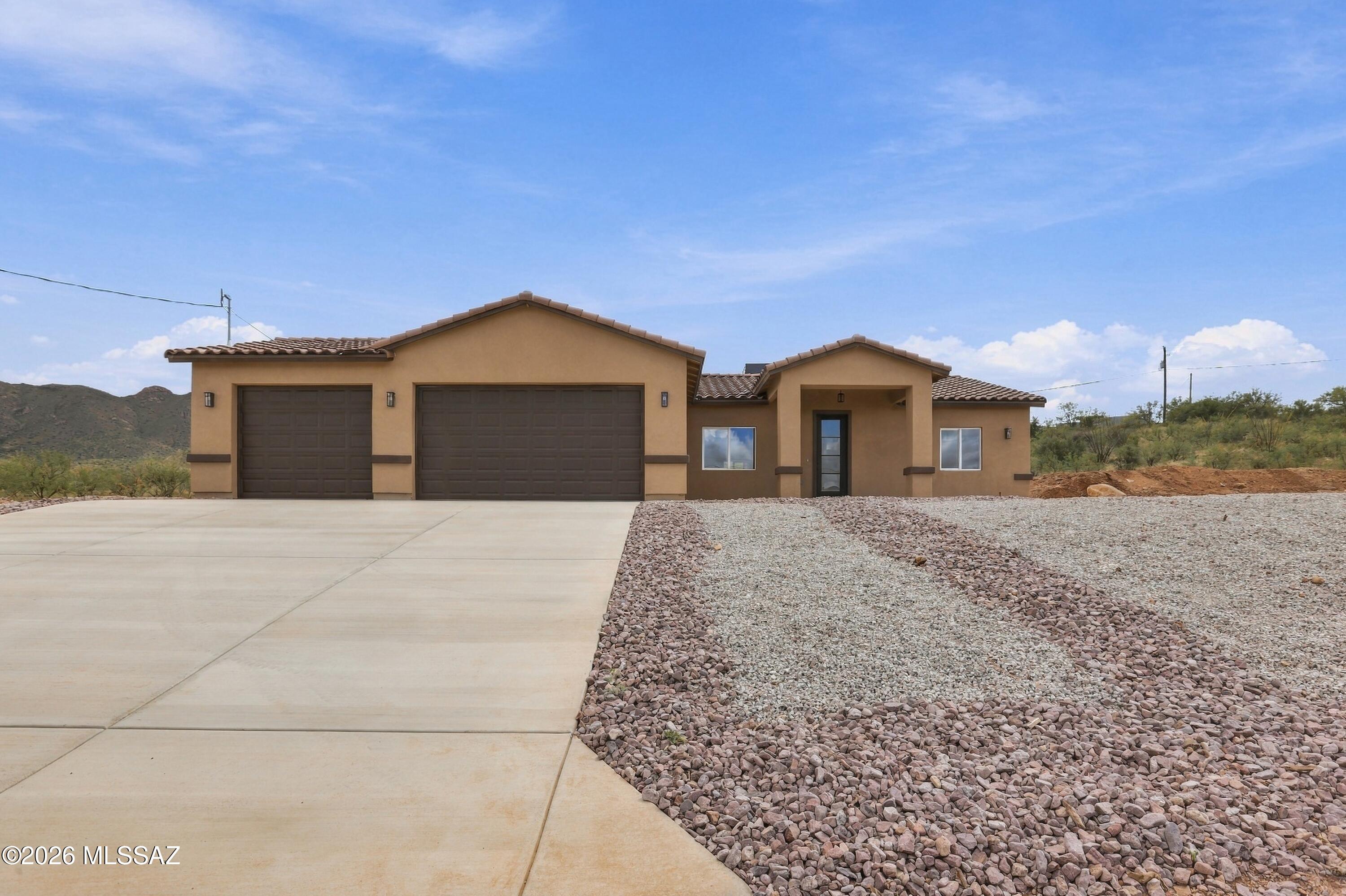 Beautifully designed new construction home featuring stunning mountain views, modern finishes, and nestled on a spacious half-acre lot. With 3 bedrooms 2 bathrooms, a 3 car garage and no HOA, this move-in-ready gem offers the perfect balance of luxury, space and tranquility in one of Southern Arizona's most scenic communities.