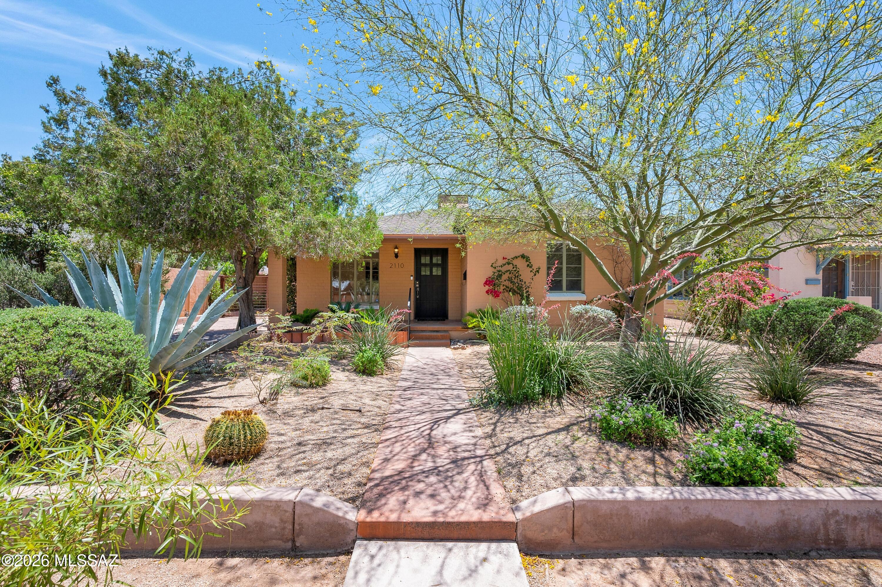 Located in the heart of Tucson's coveted Sam Hughes neighborhood, this thoughtfully updated residence blends timeless character with modern comfort and exceptional versatility. A welcoming front porch sets the tone, while the expansive rear yard and abundant off-street parking, both front and rear, provide rare convenience, including a gated paver carport for secure covered parking. Inside, the flexible split-bedroom floorplan offers privacy and functionality with two secondary bedrooms sharing a beautifully updated bath, while the primary suite features its own ensuite bath and dedicated mini split system for personalized comfort. A separate studio-style sleeping quarters with an additional mini split creates the ideal guest retreat, creative space, or private home office, (continued) complemented by a full laundry room nearby. The remodeled kitchen showcases newer stainless steel appliances, quartz countertops, crisp white cabinetry, and an adjacent dining space designed for both everyday living and entertaining. Elegant 1' x 2' tile flooring extends throughout the home, creating a clean, cohesive aesthetic. Multiple living spaces add to the home's appeal, including a welcoming front living room and an additional study, den, or lounge area just off the kitchen, ideal for remote work, reading, or relaxed gathering spaces. Outside, the nicely landscaped rear yard on irrigation creates a private setting perfect for entertaining, relaxing, or simply enjoying Tucson's beautiful outdoor lifestyle year-round. Additional upgrades include an updated electrical panel with whole-house surge protection for enhanced peace of mind and modern efficiency. Offering charm, flexibility, and modern updates in one of Tucson's most beloved historic neighborhoods, this exceptional Sam Hughes property is a rare opportunity close to the University of Arizona, downtown dining, and cultural amenities.