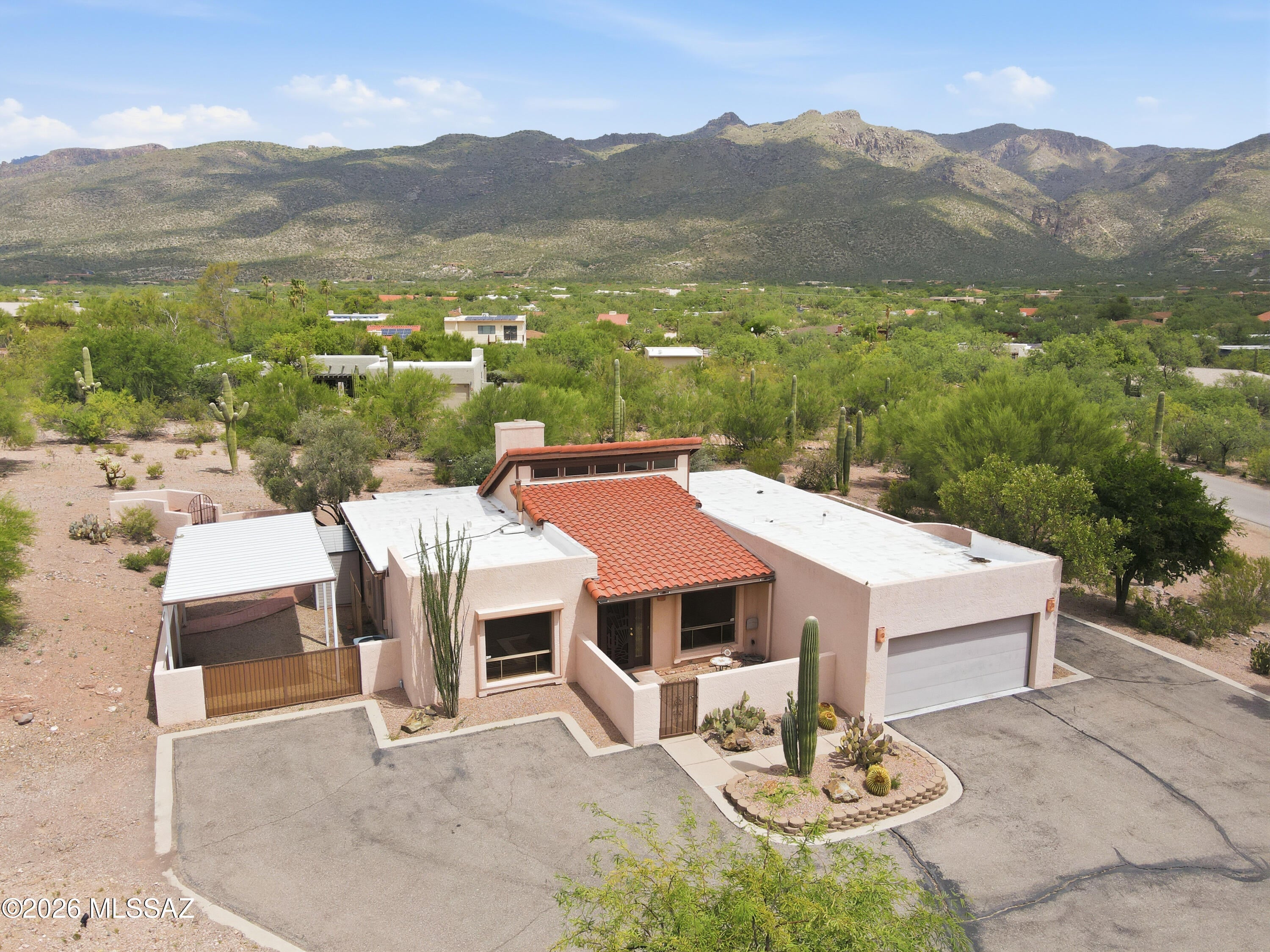 Enjoy breathtaking mountain views from this beautifully updated Tanque Verde property. The remodeled kitchen features modern finishes, ample cabinetry, and a stylish wine bar perfect for entertaining. A tankless water heater adds energy efficiency and convenience. Situated on a spacious lot, this property offers covered RV parking and plenty of room for horses, a future pool, or additional outdoor living space. Experience stunning Arizona sunrises, sunsets, and desert scenery while enjoying the privacy and flexibility this exceptional property provides. Located within the Tanque Verde Unified School District, this property combines modern updates with the beauty of Arizona living. Seller is providing a 1-year home warranty for peace of mind.