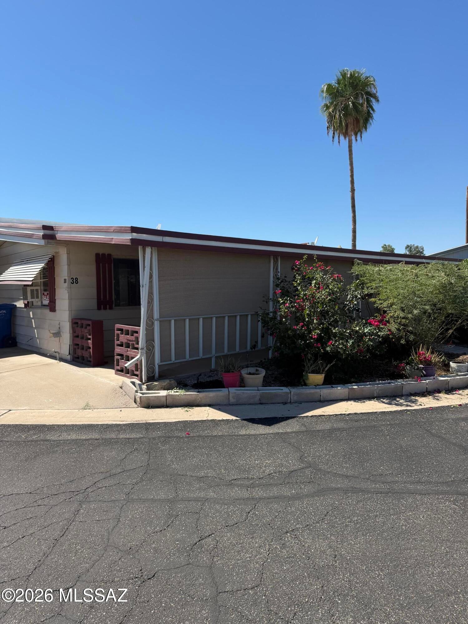 Spacious double-wide manufactured home in a gated 55+ community offering comfortable, single-level living with no steps. The recently updated primary bath includes accessibility features. Enjoy a large covered porch, covered carport, and an electrified storage shed. Community amenities include a pool, hot tub, shuffleboard, horseshoes, recreation room, fitness center, banquet room, and full kitchen. Enjoy mountain views and stunning Arizona sunsets. Small pets welcome; dogs under 30 lbs. Lot rent is $700/month, including water and trash. Park approval required. No rentals.
