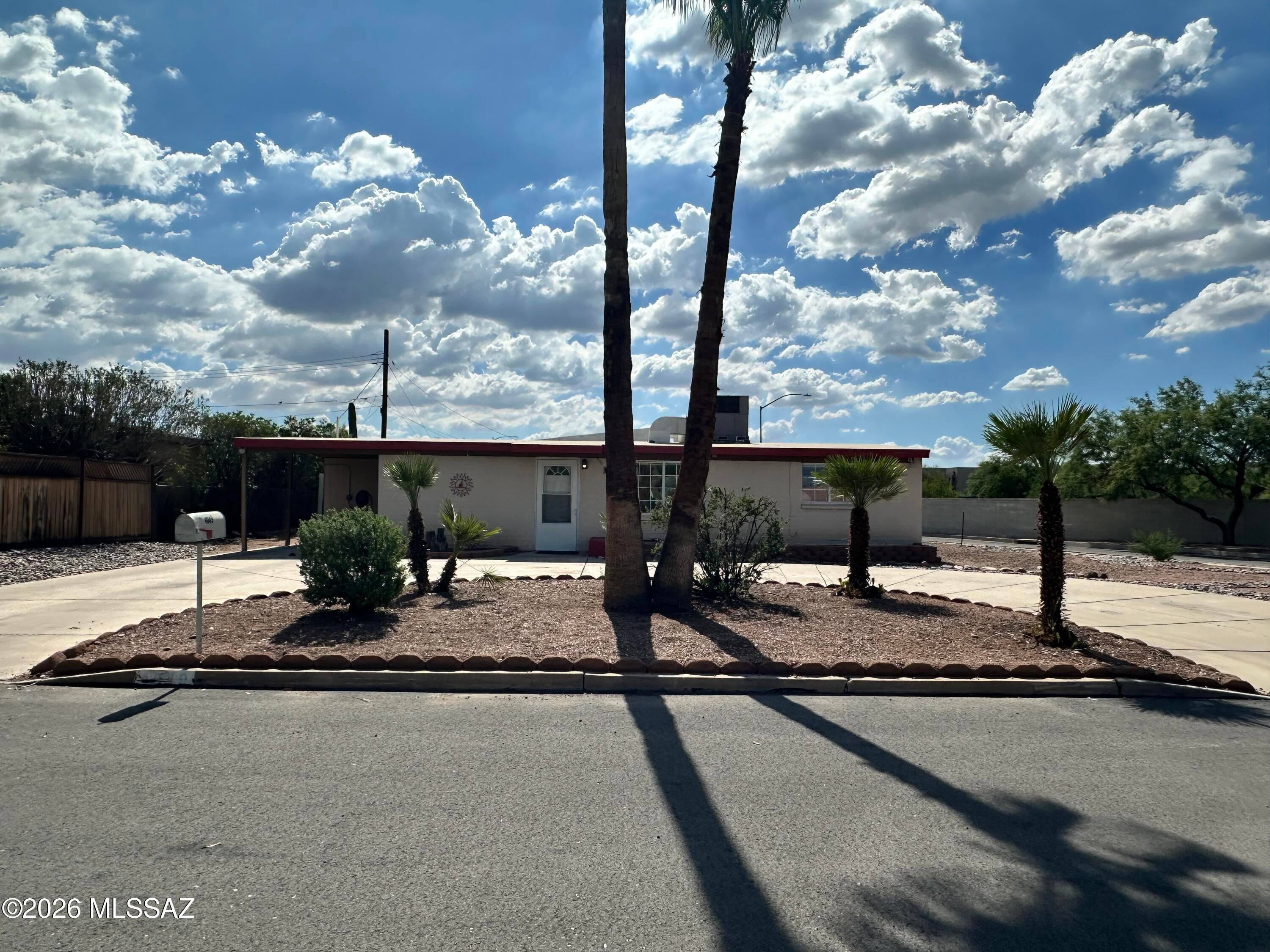 Home sweet home! This 3bed/2bath home is ready for you! Close to the Tucson Mall, restaurants, and much more! Horseshoe driveway and level 2 EV charger in carport for your convenience! Step into the spacious living area connected to the kitchen, complete with lots of cabinet and counter space! Primary bedroom features walk-in shower with beautiful tiled walls. Other bedrooms are spacious, too! Laundry room with Washer/Dryer included as convenience. Backyard is huge with semi-enclosed patio space to keep you cool! Shed available in backyard for extra storage! A/C and no carpet throughout! Don't miss out!