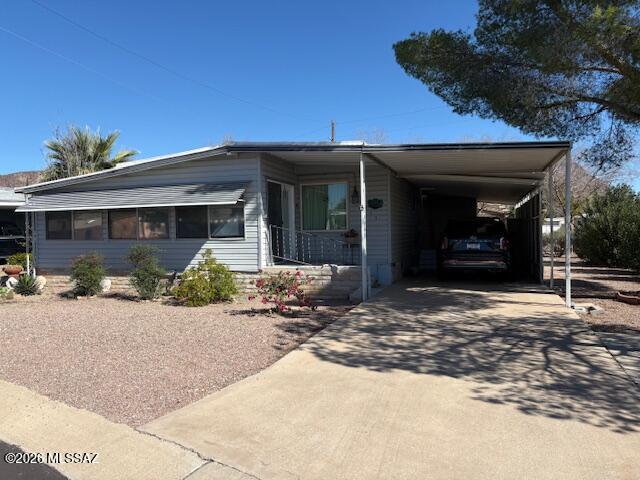 Very nice and well cared for home close to the golf course with great mountain views from the AZ room!  Newer kitchen cabinets. New dining room window with great sunset views. AZ room wraps around side and front of home creating a large livable space with a vent from the main house for heating and cooling. Taped and textured walls and ceilings. Chain link fence surrounds property. Private sitting area in the back. Located in an active 55+ community, the HOA fee includes unlimited golf, tennis, pickleball, shuffleboard, pools, spa, fitness center, trash service, and much more. Best of all—you own the land. This is carefree living at its finest.