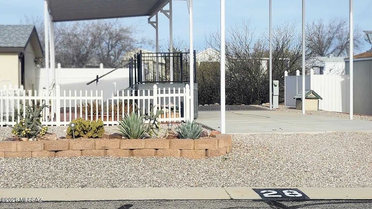 3759 sq ft RV lot in the 55+ gated area of Cochise Terrace. The awning covers the rig and driveway/patio. 
The finished shed comes complete with a washer and dryer and AC. 
If you have pets you'll see that the lot in fenced in for their safety. 
The lot backs up to the natural wash area. 
Oh yeah, the driveway and the pad for the RV are concrete.