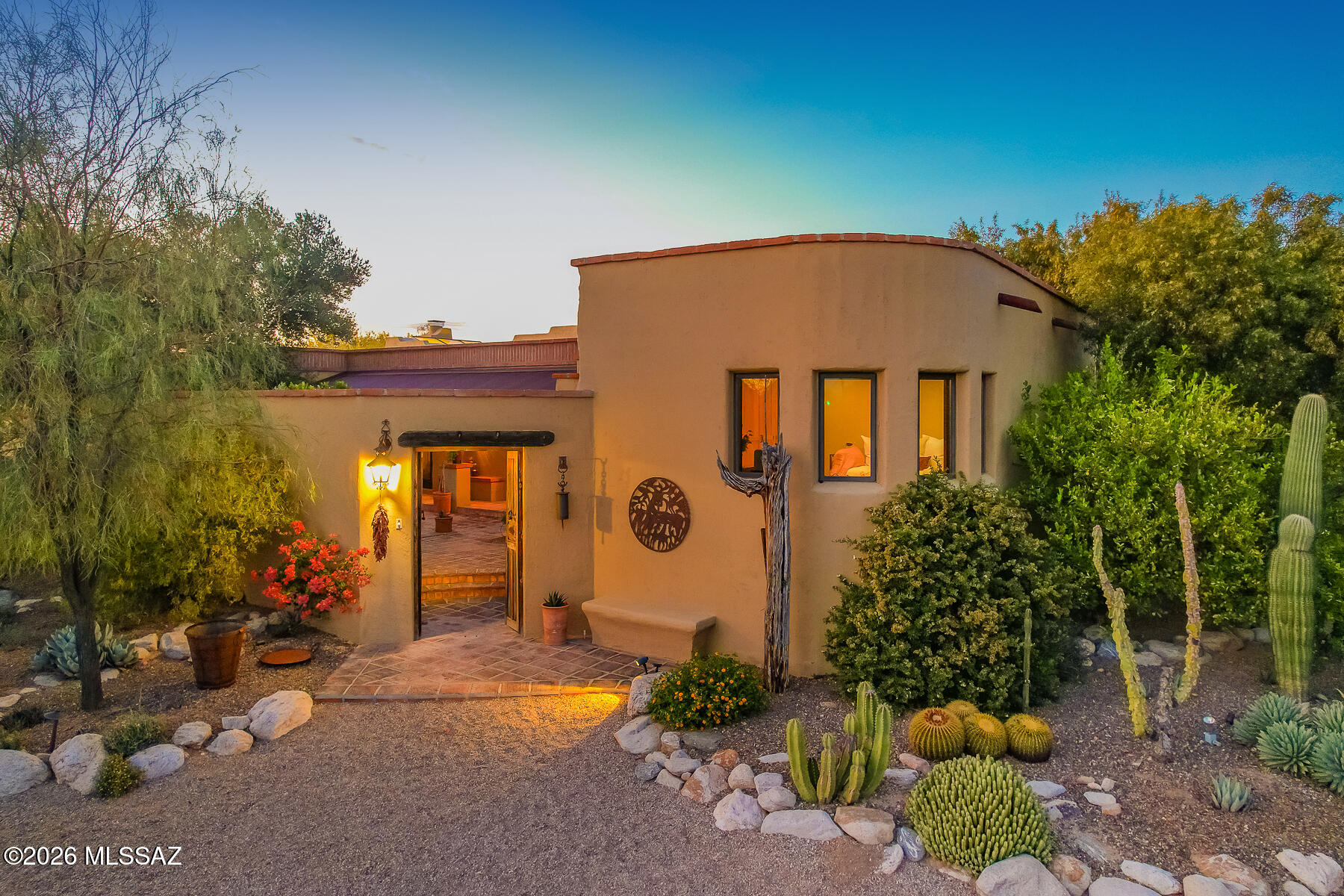 Located in the heart of Tucson this home represents the history and elements of the Sonoran Desert. Experience the ultimate desert lifestyle in this truly amazing home with resort like outdoor living spaces. This Hacienda style 4-bedroom, 3-bath home is brimming with character, amenities, privacy, views and located on 1.22 acres at the end of the cul-de-sac. Full library with wood plank floors, living room w/saguaro ribbed ceilings, vigas and a fireplace, fully remodeled kitchen w/mesquite center island, custom cabinets and updated bathrooms. The entrance to the home includes a huge front courtyard with banco seating, covered patio and a beautiful garden area. The front entrance, door is surrounded w/custom tile and steps to an office/4th bedroom as a separate entrance.  Nature abounds in the serene backyard and is an entertaining oasis with BBQ, fireplace, covered patio, banco seating, pool/spa, water feature and mountain/sunset views.  Enjoy the fruit from the lemon, lime and grapefruit trees and for the gardeners 3 raised/covered garden beds.