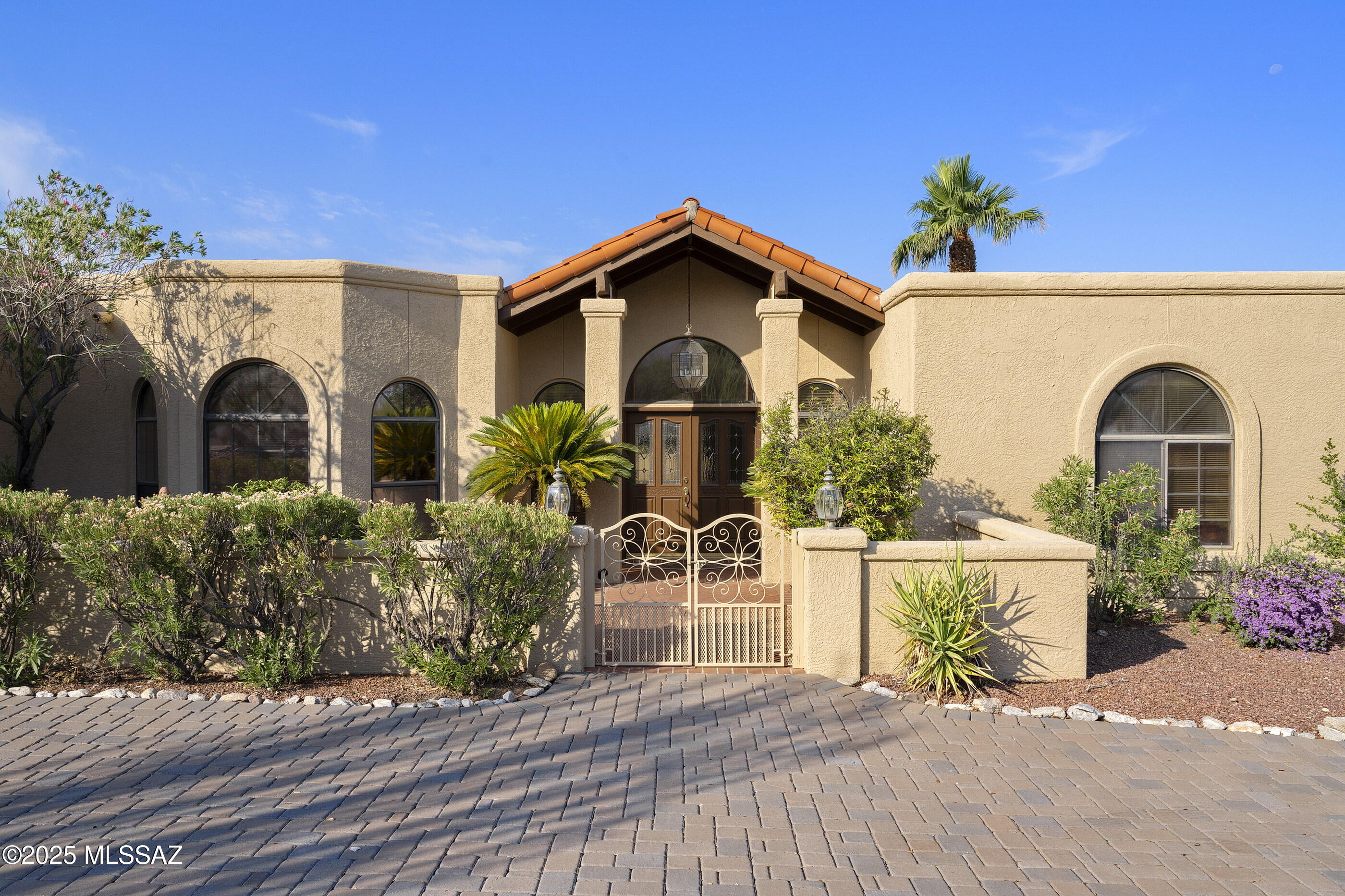 Beautiful custom home on 1.8-acres in established Catalina Foothills Estates No. 9 neighborhood. Enjoy exquisite Catalina Mountain and desert views in this 4 bedroom and 3 bath home with mother-in-law suite. New roof 2021 and freshly painted exterior 2025. The chef's kitchen is complete with granite countertops, Viking stainless steel appliances, center island, and a well-lit breakfast nook. The family room features exposed wood ceilings and a custom-designed gas fireplace. The spacious backyard has full-length covered patios, lush natural desert plantings, and a pool and hot tub. Within walking distance of premium shopping and dining at La Encantada Shopping Center and conveniently located near the Campbell Avenue corridor, Orange Grove Middle school, and Catalina Foothills High School.