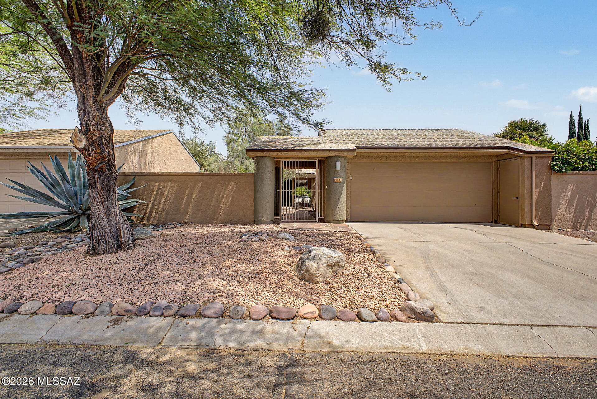 TURN-KEY and move-in ready! Beautifully updated 2-bedroom, 2-bath home with a 2-car garage in the desirable Bosques Creek neighborhood! Roof redone in 2024. Residents enjoy access to the beautiful community pool, as well as the scenic bike and walking trail along the Rillito River. The community has a 13 acre private natural preserve /habitat as part of our amenities. Surrounded by green space and outdoor recreation opportunities, this home is perfect for nature lovers and outdoor adventurers alike. This charming property welcomes you with a privately enclosed front courtyard. Inside, you'll find vaulted ceilings, skylights, abundant natural light, and stylish tile and beautiful vinyl flooring throughout. The open-concept living and dining areas create an inviting space perfect for for relaxing or entertaining.

The upgraded kitchen features stainless steel appliances, Corian countertops, recessed lighting, designer tile backsplash, a decorative pantry cabinet, white shaker cabinetry, and a peninsula with a stunning live-edge wood breakfast bar. 

The spacious primary suite includes a separate entrance to the backyard, a walk-in closet, and a beautifully designed ensuite bathroom with dual vanities, and a large shower with a glass enclosure. The secondary bedroom is ample size and features a private bathroom with a sliding barn door- ideal for overnight guests. 

Step outside to your peaceful backyard retreat complete with mature landscaping, paver patio, and low-maintenance artificial turf. Don't let this gem slip away!