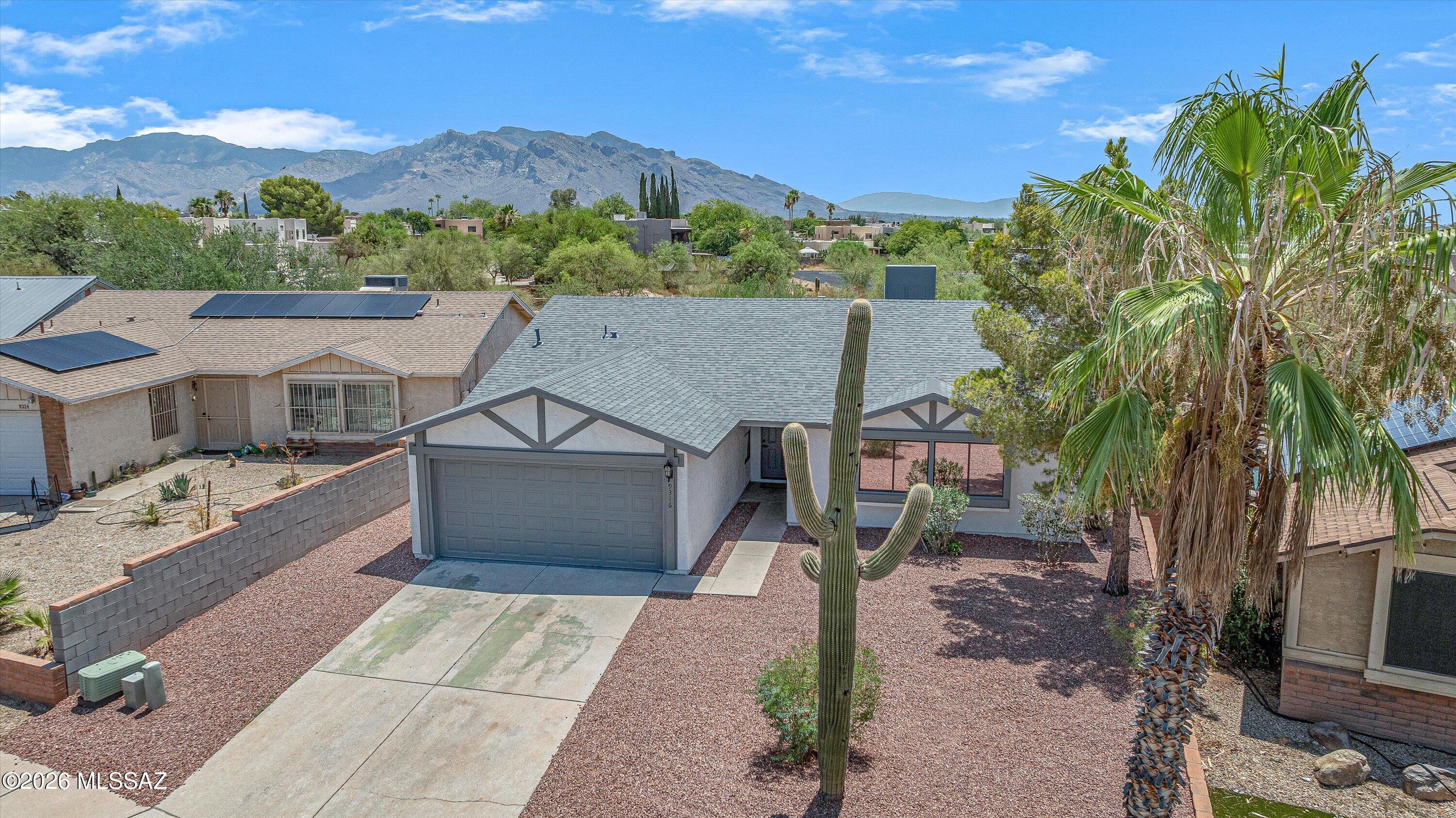 Fresh, stylish and completely move-in ready! This beautifully remodeled 4-bedroom, 2-bath home has a bright, open feel with vaulted ceilings and an easy-flow great room layout. The kitchen takes center stage with a large island, quartz countertops, upgraded soft-close cabinetry, matte black hardware, workstation sink and stainless steel appliances.  Wood-look LVP flooring runs throughout--no carpet--and updates continue with new doors, trim, baseboards and hardware. The spacious primary suite features a walk-in closet and private bath with dual vanities, while both bathrooms have been refreshed with custom tiled showers and designer niches. The big-ticket items are already handled too, including a new roof with warranty, 2024 HVAC and new water heater. Out back, enjoy a covered patio, fully fenced backyard and natural desert greenbelt directly behind the home--giving you extra privacy with no rear neighbor. Low-maintenance landscaping and NO HOA make this one easy to love and easy to own. Move in, unpack and enjoy!