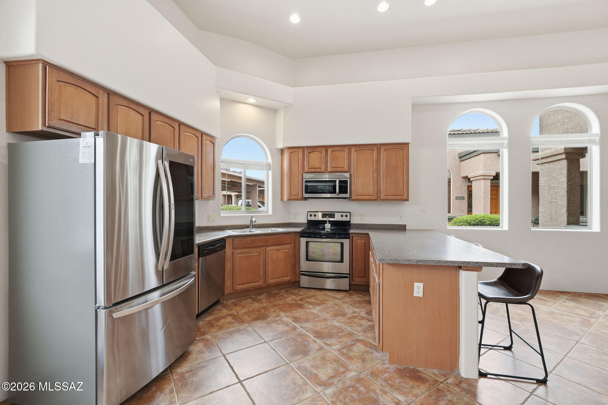 This amazing single-story townhouse is located in the Tucson Mountain Sanctuary and offers mountain views. Upon entering, you will find a stunning great room with high ceilings and an open kitchen concept featuring all-stainless-steel appliances. The townhouse features three bedrooms and two full baths. Enjoy tile flooring throughout, new carpet in the bedrooms, an enclosed sunroom, a front patio for outdoor enjoyment, new AC, and a freshly painted interior. The well-maintained community includes a pool and is conveniently located near shopping and schools, and is just minutes from the University of Arizona, Pima West, and major highways I-10 and I-19. This property is a must-see!