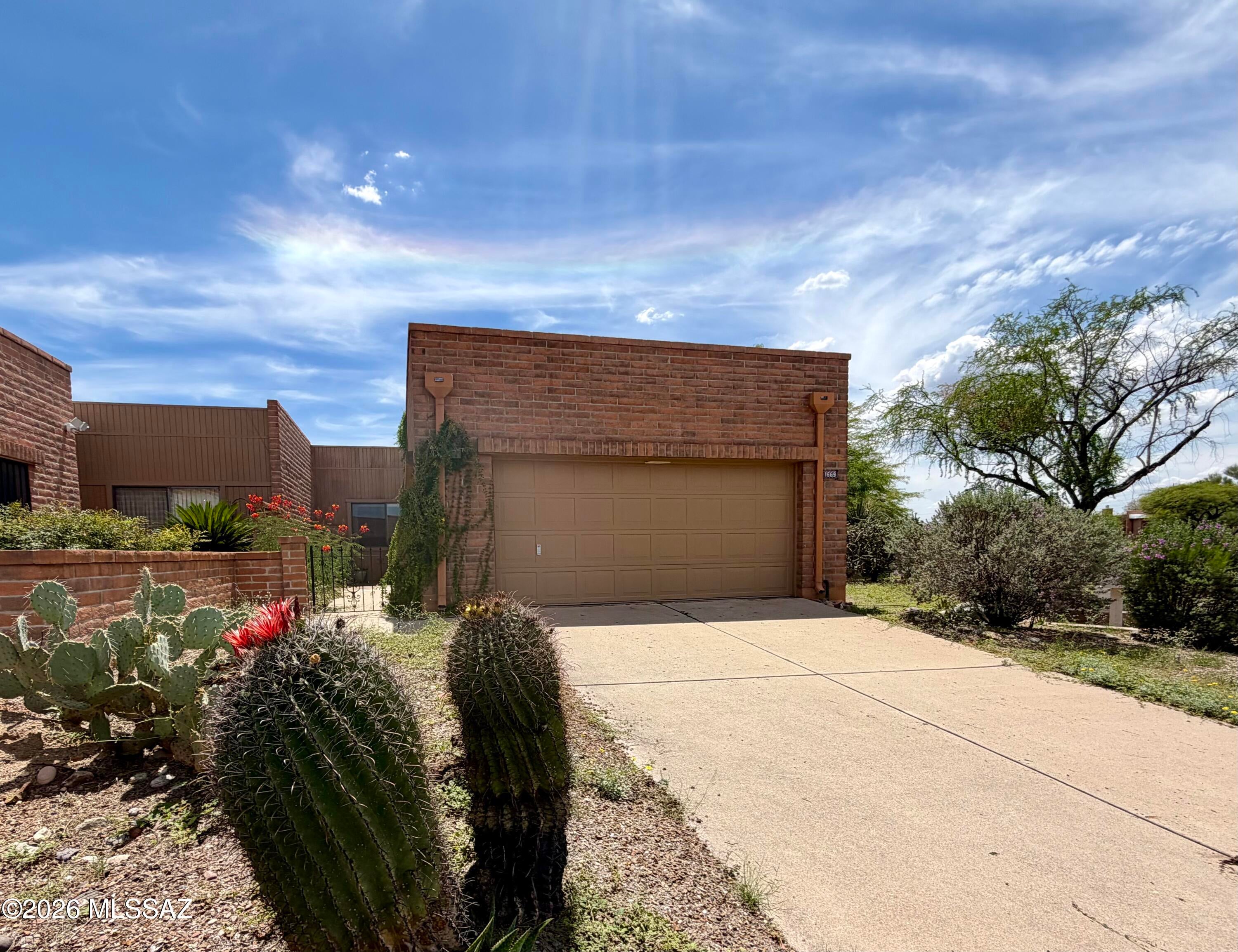 Charming Southwestern-style home, where classic Arizona character meets an inviting, easygoing setting. Distinctive slump-block brick exterior, mature desert landscaping and private entry courtyard create wonderful curb appeal, while the interior offers high ceilings, graceful arched openings and abundant natural light. Spacious living area is highlighted by a traditional beehive fireplace and sliding glass doors that open to the outdoor living space, with mountain views, creating an excellent flow for relaxing or entertaining. Kitchen has warm wood cabinetry and provides practical layout with plenty of storage. Back gate is steps away from the bocci and pickleball courts. Plentiful nearby amenities from the Green Valley Recreation 55+ community.