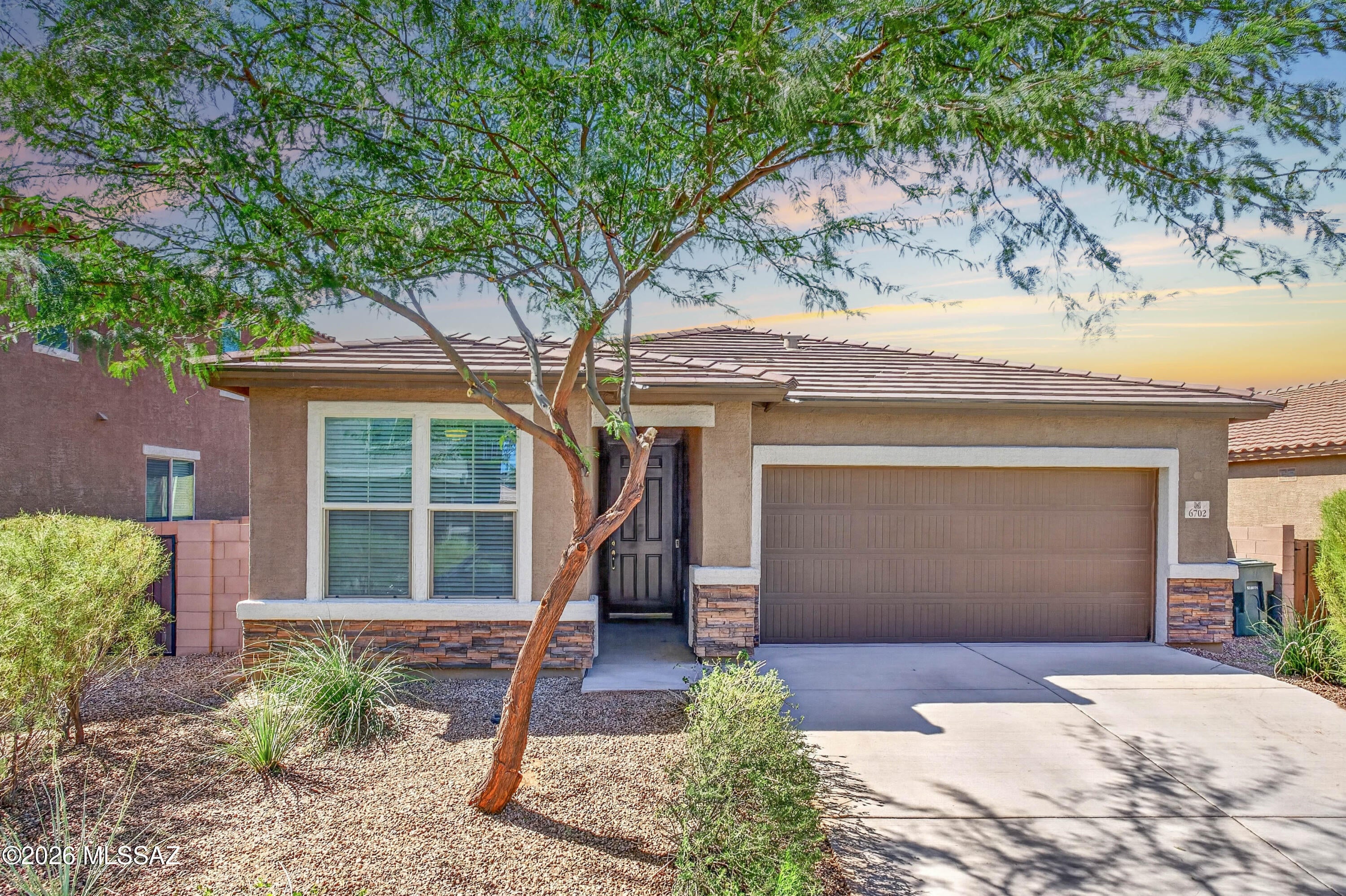 Single story, 4 bedroom home with 3 FULL bathrooms (including ENSUITE with attached bathroom) in popular La Estancia community in VAIL SCHOOL DISTRICT!  Welcome to this beautifully maintained Richmond American home built in 2022, featuring 1,878sqft and a bright, open floor plan with abundant natural light. A welcoming entry with decorative stone adds charming curb appeal.  The spacious kitchen features granite countertops, tons of cabinetry, an oversized island, and a massive walk-in pantry. An electric range with gas hookups behind offers added flexibility. The generous primary suite includes a large closet and private bathroom with dual vanities and a separate toilet room. A secondary bedroom/ensuite with an attached full bathroom is ideal for guests or multigenerational living. Additional highlights include a two-car garage with a soft water loop, a laundry room with extra shelving, and all appliances included, including refrigerator, washer, and dryer. Low-maintenance front and back yards provide more time to enjoy your home and community.  Located in sought-after La Estancia, this home offers access to the award-winning Vail School District and is within walking distance of the community pool, splash pad, and park. Enjoy convenient access to Davis-Monthan Air Force Base, Interstate 10, the Chuck Huckleberry Loop, Downtown Tucson, the University of Arizona, and the Pima Air & Space Museum.  Here, you'll have a floor plan to fit your needs, in a fantastic location! Welcome home!