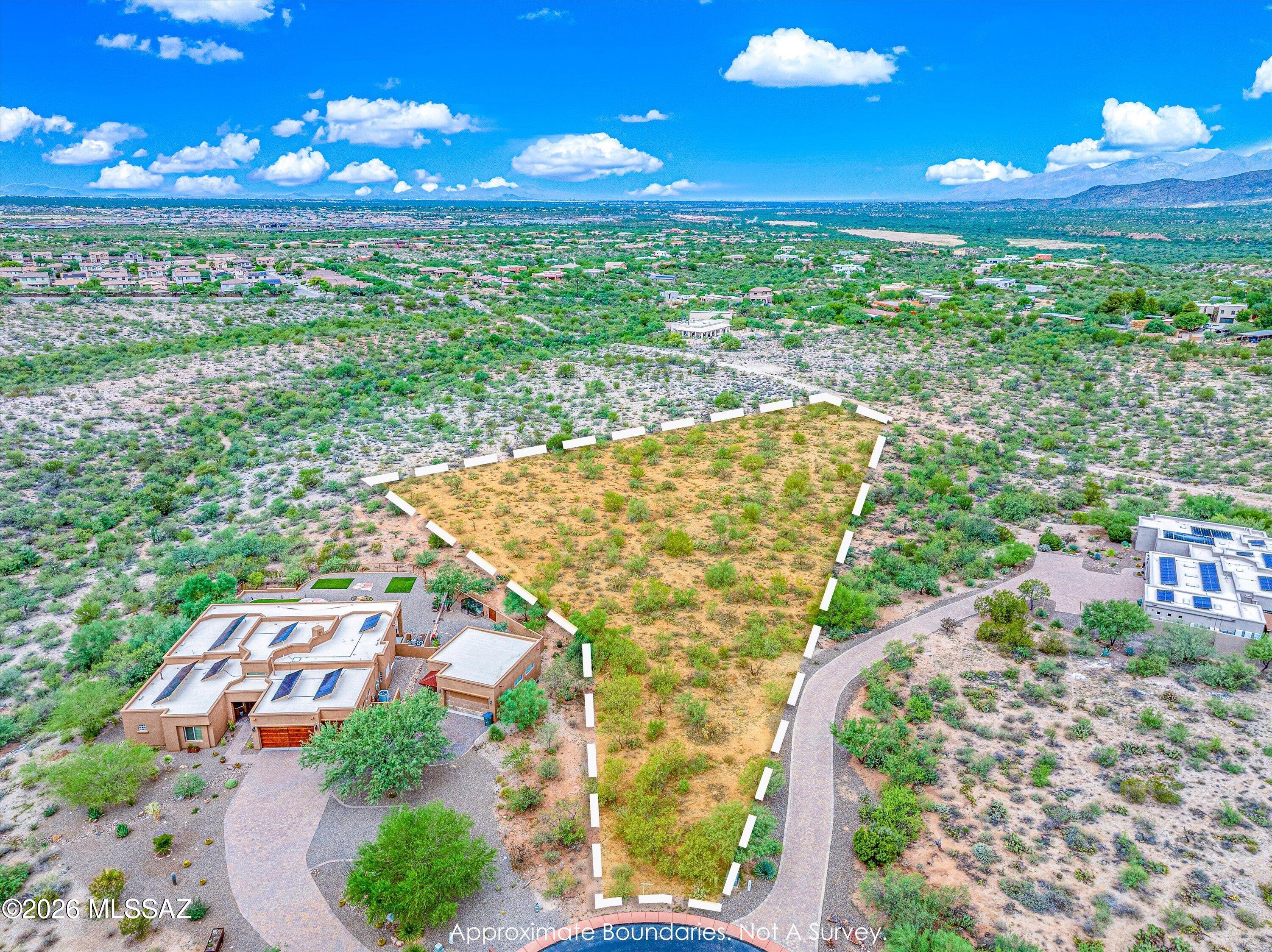 Gated master-planned community in Vail's Rincon Valley Foothills -- 404 custom homesites, with 75% of Coyote Creek platted as permanent natural open space. This 2.12-acre lot offers wide views in every direction. Amenities established since 2004: a recreation center on approx. 12 acres with pickleball, tennis, and basketball courts, playground, and BBQ area, plus an equestrian center on approx. 17 acres backing to state land with two 16-stall barns, two hay barns, an arena, and two round pens. Miles of dedicated trails. 25 minutes to major employers and Tucson International Airport, 35 to downtown Tucson. HOA $630 semi-annually.