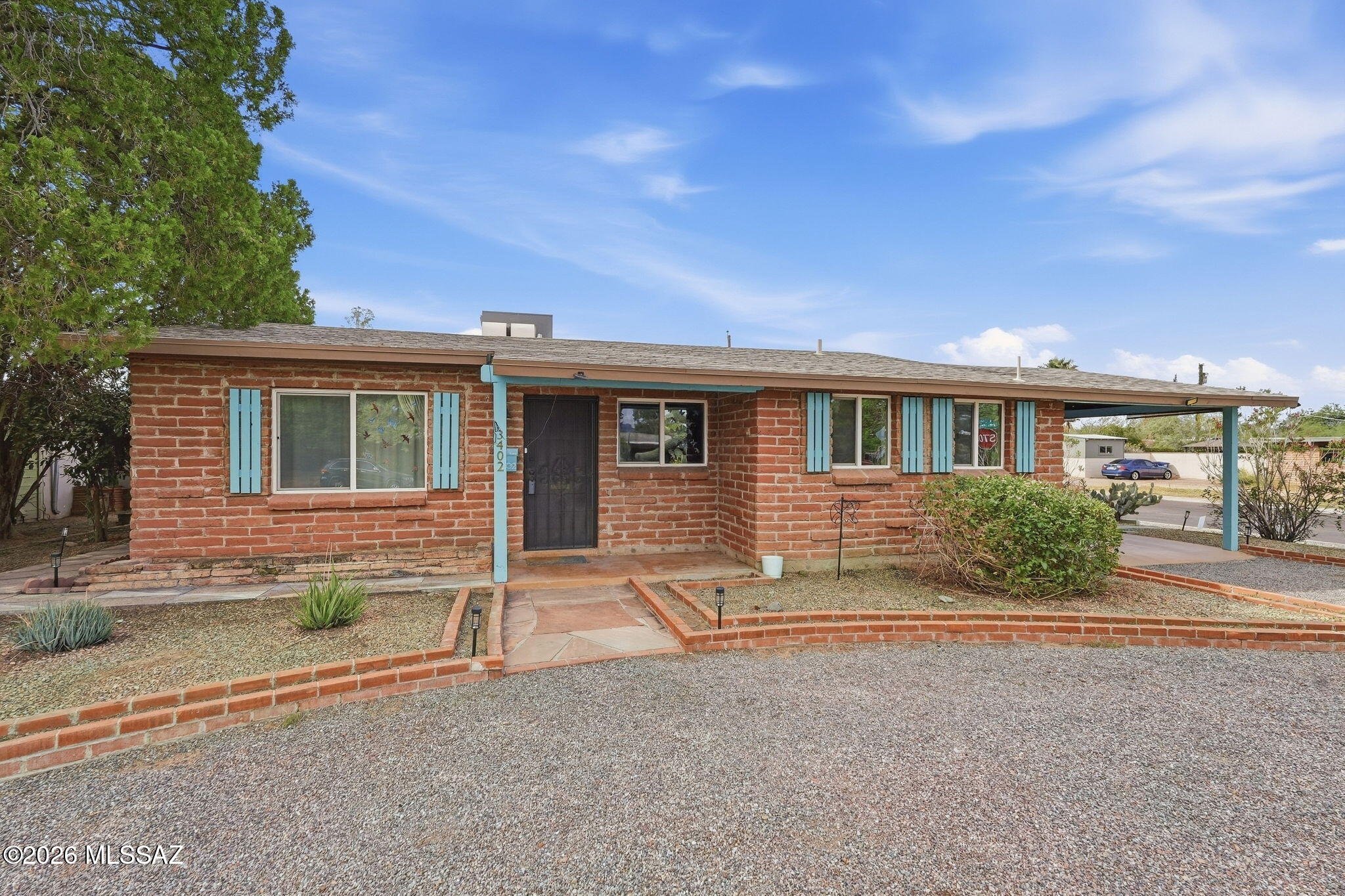 Charming mid-century modern adobe brick home in a desirable central Tucson neighborhood with Catalina Mountain views. Lush desert landscaping includes two dozen cacti and two towering saguaros, and the large backyard draws birds, rabbits and other wildlife. Rooftop solar cuts electric bills, and the all-electric home has an efficient heat pump. A separate studio has private front and rear entrances, a mini-split and a discreet laundry closet, making it ideal for an artist, office or workshop. Remodeled to keep its mid-century character, the home has an updated kitchen with granite counters, custom concrete floors, updated baths and dual-pane windows, and is wired for fiber optic internet. Room for a pool or garden. Close to UA, Tucson Botanical Gardens, parks, dining and shopping.