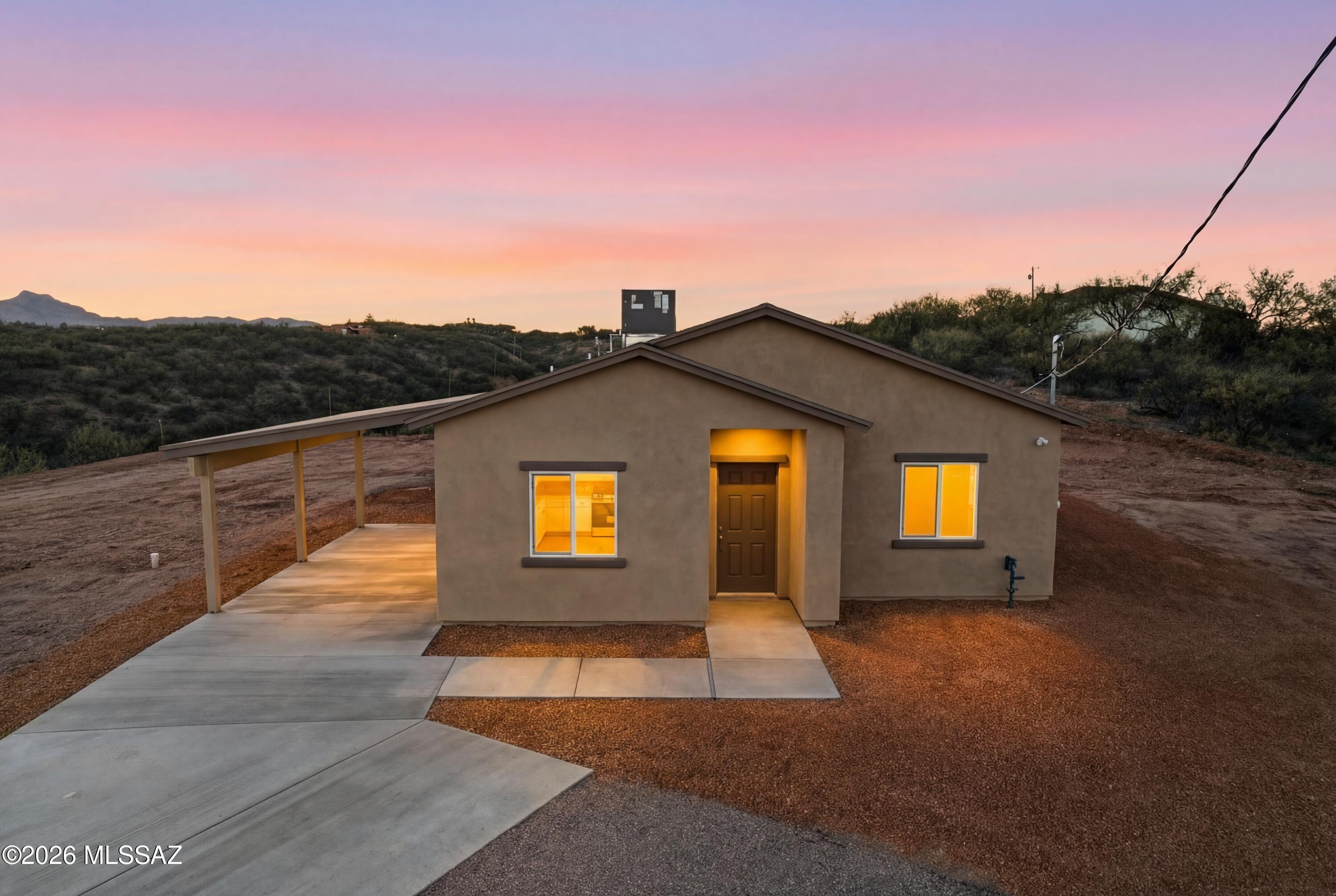 BRAND NEW CONSTRUCTION HOME QUALIFIES FOR USDA/0% down!  Ask me for details!!  Beautiful turn-key ready home sits on 2.51 acres on top of a hill with 360 degree views! Come inside and walk this well laid out open floor plan including an open kitchen featuring new stainless-steel appliances and a neutral color palette. This home has 3 bedrooms, 2 bathrooms and no HOA and located off a paved road. All bedrooms have a very spacious feel with tile throughout, and they also all have ceiling fans already installed. Sweeping mountain views from every direction. Home is located a few miles from I-19 making it a very easy commute to Tucson, Nogales and surrounding areas. Call me to schedule your showing today, Rio Rico still leads the area when it comes to affordable housing!