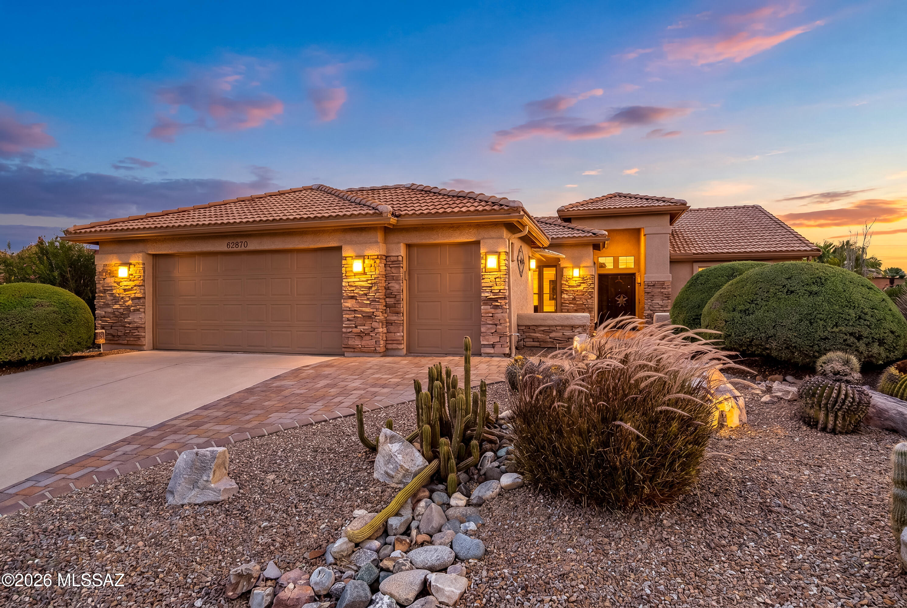 Experience desert living at its finest in this beautifully upgraded Laredo model with an exceptional detached casita, ideally situated on a desirable corner homesite in the golf community of SaddleBrooke. The main residence offers 1,912 sq ft, complemented by an impressive 540 sq ft casita complete with a full bath, kitchenette area, built-ins and endless flexibility for guests, hobbies, a private office, studio, fitness room, or multi-generational living. From the moment you arrive, the inviting front courtyard captures stunning mountain views and creates the perfect setting for morning coffee, evening wine, or quiet desert sunsets. Inside, custom features and thoughtful upgrades create warmth and character throughout. The spacious great room showcases a dramatic see-through fireplace while French doors bring natural light and seamless indoor-outdoor living. The kitchen offers stainless steel appliances, gas cooking, generous cabinetry, a double-door pantry, and inviting spaces for gathering and entertaining.
Additional highlights include ceiling fans and updated lighting, attractive tile flooring including wood-look finishes and terracotta accents, and an extended garage with golf cart space, built-in storage cabinets, utility sink, and attic access.
Step outside to enjoy a full-length covered patio, spacious paver entertaining areas, a hot tub, and a built-in BBQ leading to the remarkable detached casita retreat. Located within one of Southern Arizona's premier active adult golf communities, this home combines flexibility, views, charm, and lifestyle all in one unforgettable home.