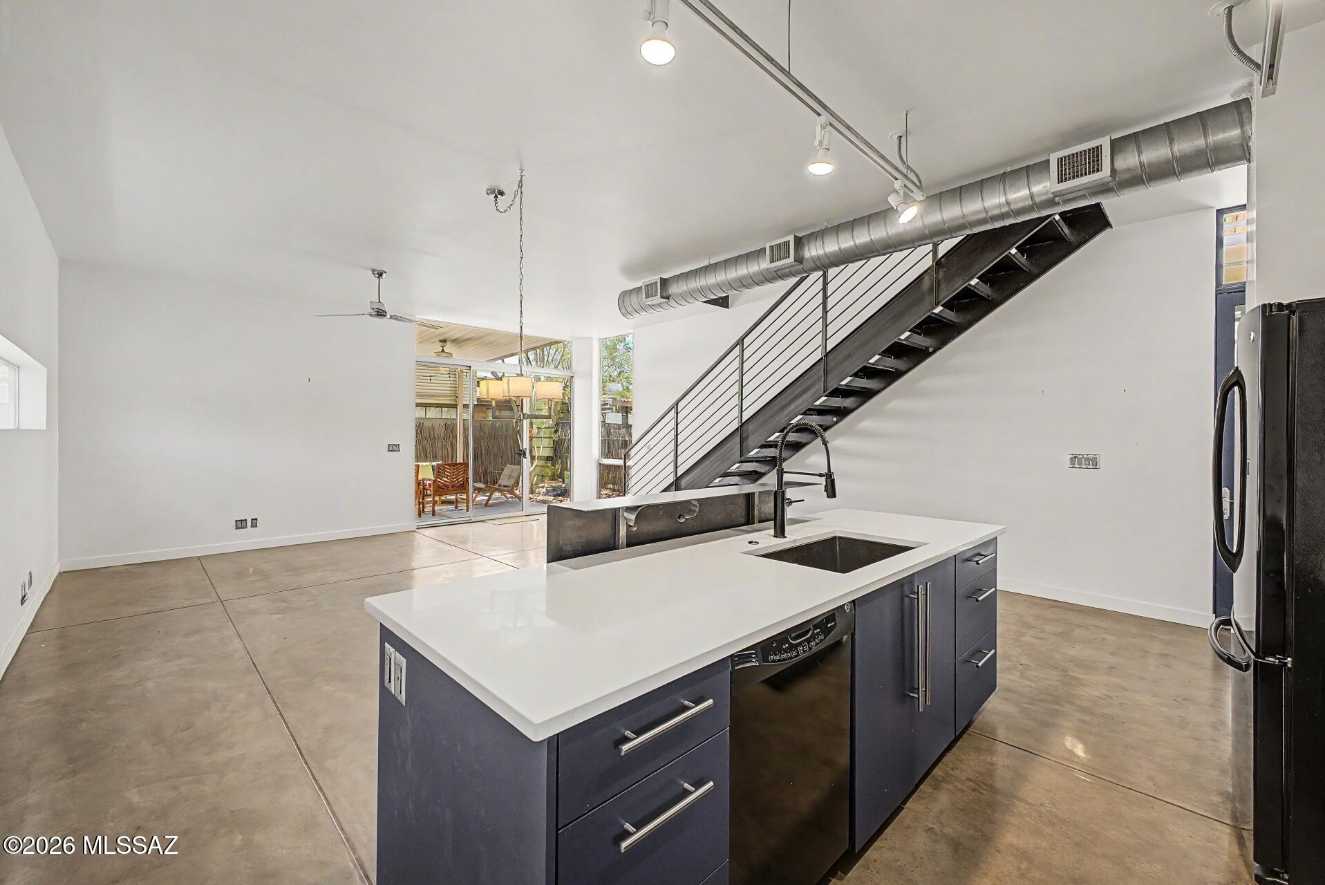 **FULLY OWNED SOLAR, GATED COMMUNITY AND LOW HOA DUES** Live in the center of Tucson but enjoy this industrial style gem! Designed by renowned architect Rob Paulus, this is one of 11 single family homes in a centrally located gated community. Custom cabinetry and a steel stair define clean lines while windows are positioned to private courtyard space and the wonderful big blue desert sky. One bed and bath are on the main level. The second story can be your private retreat! The primary bedroom has access to a shaded balcony, large bathroom with double vanity and a laundry closet, plus a second bedroom- perfect for a studio or hobby room! Enjoy the community salt water pool and the close proximity to grocery stores, restaurants and UofA! Visit https://robpaulus.com/projects/indigo-modern/