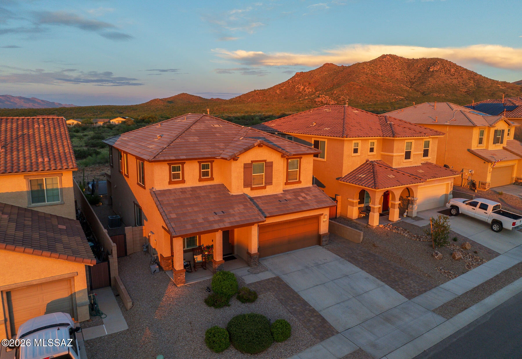 Views all around! This 2019 Lennar home in Santa Rita Ranch offers 5 bedrooms, 3 full baths, and a setting that stands apart. Enjoy front-facing mountain, city, sunset, and common-area views, plus rear views of mountains and natural desert. The backyard is ready for entertaining or relaxation with a covered patio, extended pavers, artificial turf, desert landscaping, hot tub, fire pit, and seating area. Inside, an open kitchen with granite counters, gas cooktop, double ovens, and stainless appliances flows into the dining area and family room. A downstairs bedroom and full bath add flexibility, while upstairs features a loft, split-bedroom plan, and spacious primary suite. Award-winning Vail School District. See attached features list for additional details!