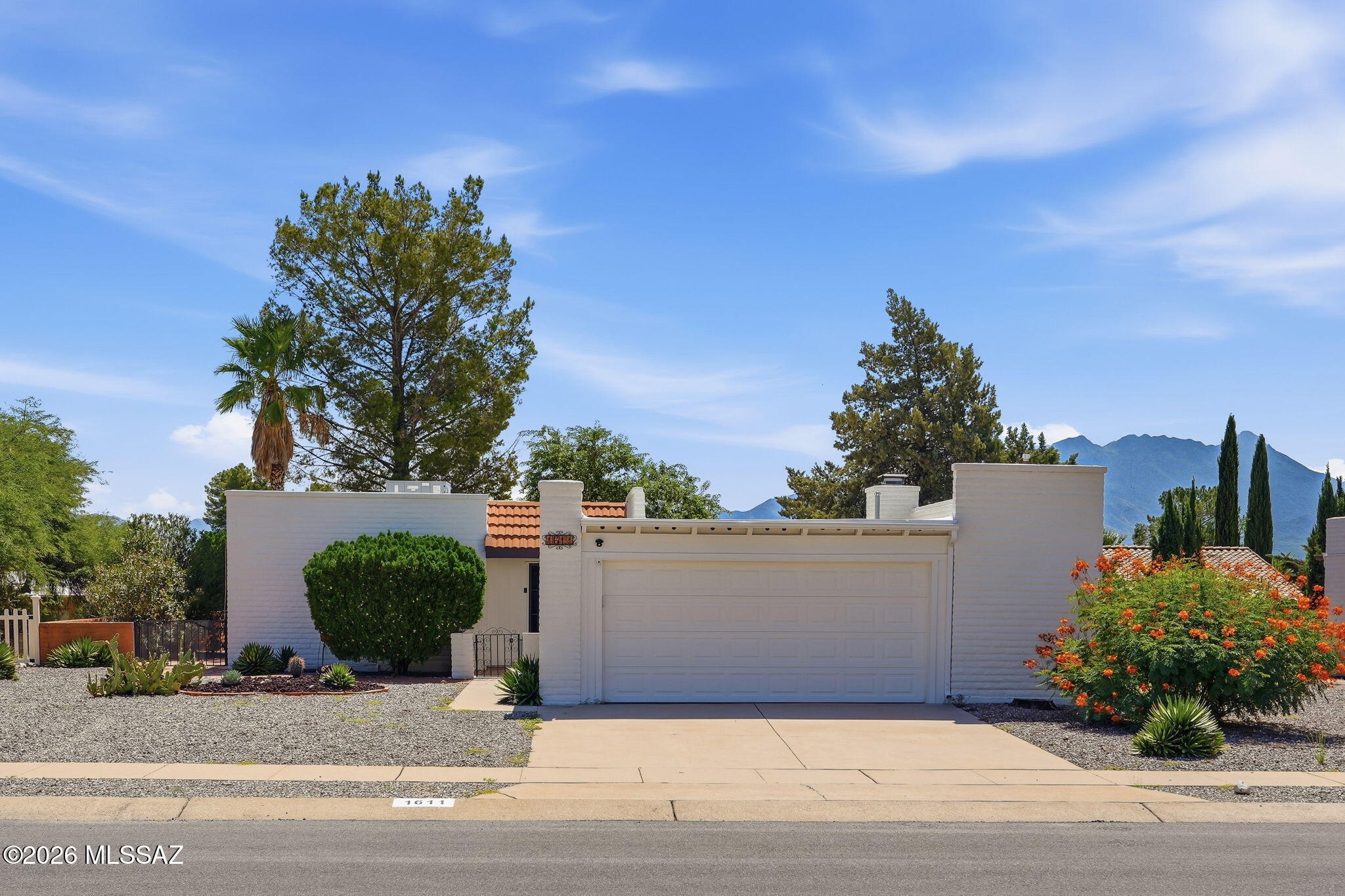 Lovely home in Desert Meadows with mountain views from the back patio. This home also has an additional Arizona Room off of the living room and primary bedroom. You can cozy up to the gas Beehive fireplace on those crisp winter days. This home also has a Murphy bed in the guest room with attached bookcases. Home has recently had the roof redone, exterior painted, new rain gutters installed, new solar screens, along with a new air conditioner and hot water heater., and the tile has been stripped and sealed. This house is ready for you!