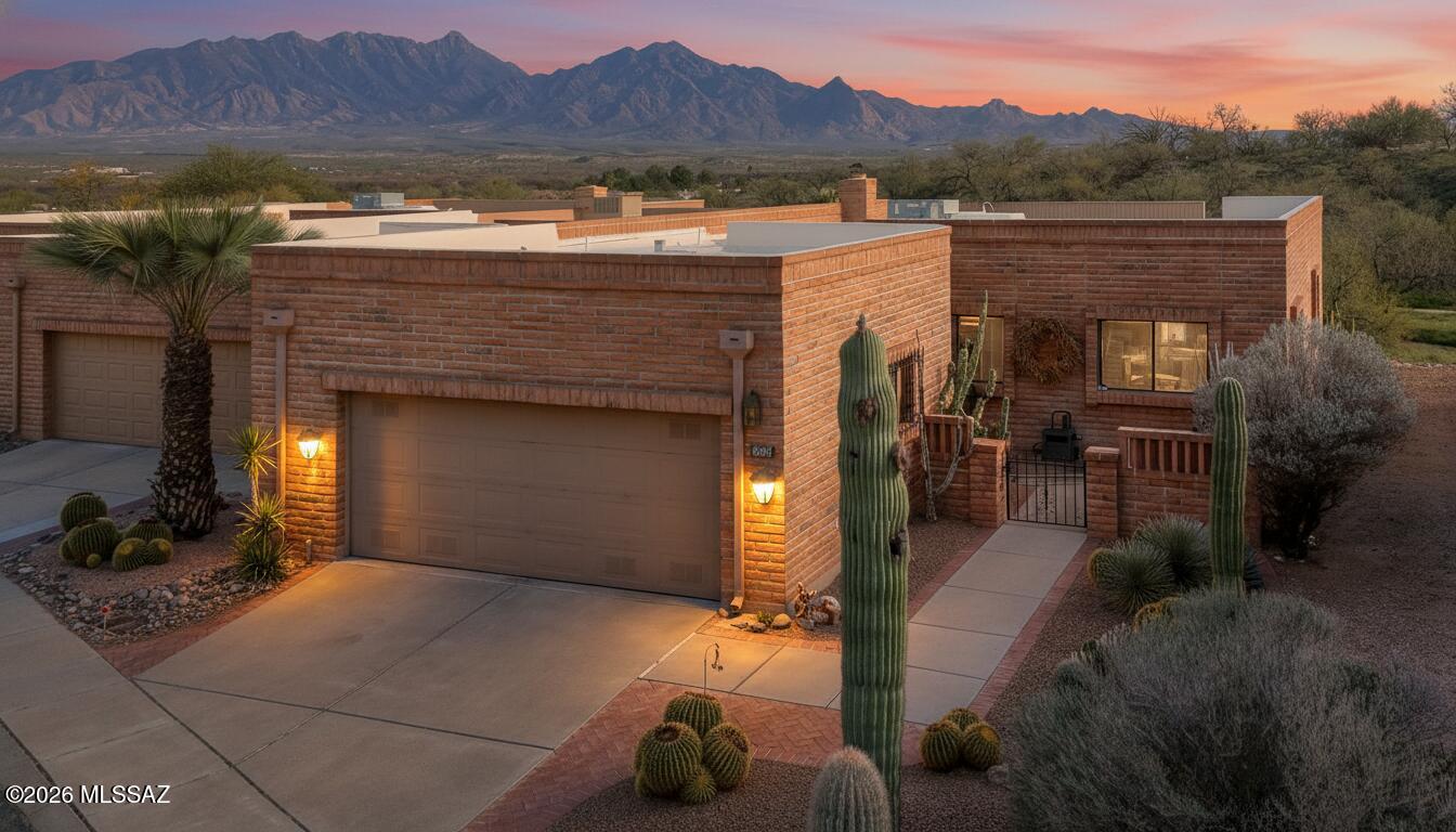 Some homes are just meant to be lived in -- and this stunning townhome is one of them. Wake up to breathtaking Santa Rita Mountain views from this beautifully updated townhome in Southwest Arizona. The perfect lock-and-leave lifestyle awaits -- low maintenance, low care, and full of charm.
The open living and dining area frames sweeping views of the mountains and desert sky, with sliders that invite the outdoors in. Step onto your private back patio and entertain friends, dine al fresco, and make memories beneath a vast Arizona sky. The kitchen has been thoughtfully updated, and features a spacious open pantry with a  coffee/wine bar!  Your primary suite has a beautifully updated tiled walk-in shower and new vanity.   A flexible guest room doubles as an artist's studio or den -- ready for whatever inspires you.  The den looks over the front courtyardready for whatever inspires you. The den looks over the front courtyard and a murphy bed stands ready to host guest overflow.  Spend your winters hiking and biking in the warm desert sun rather than tending a yard. This is the Arizona outdoor lifestyle at its finest: more trails, more sunsets, more living, with a beautiful place and beautiful VIEWS to come home to!