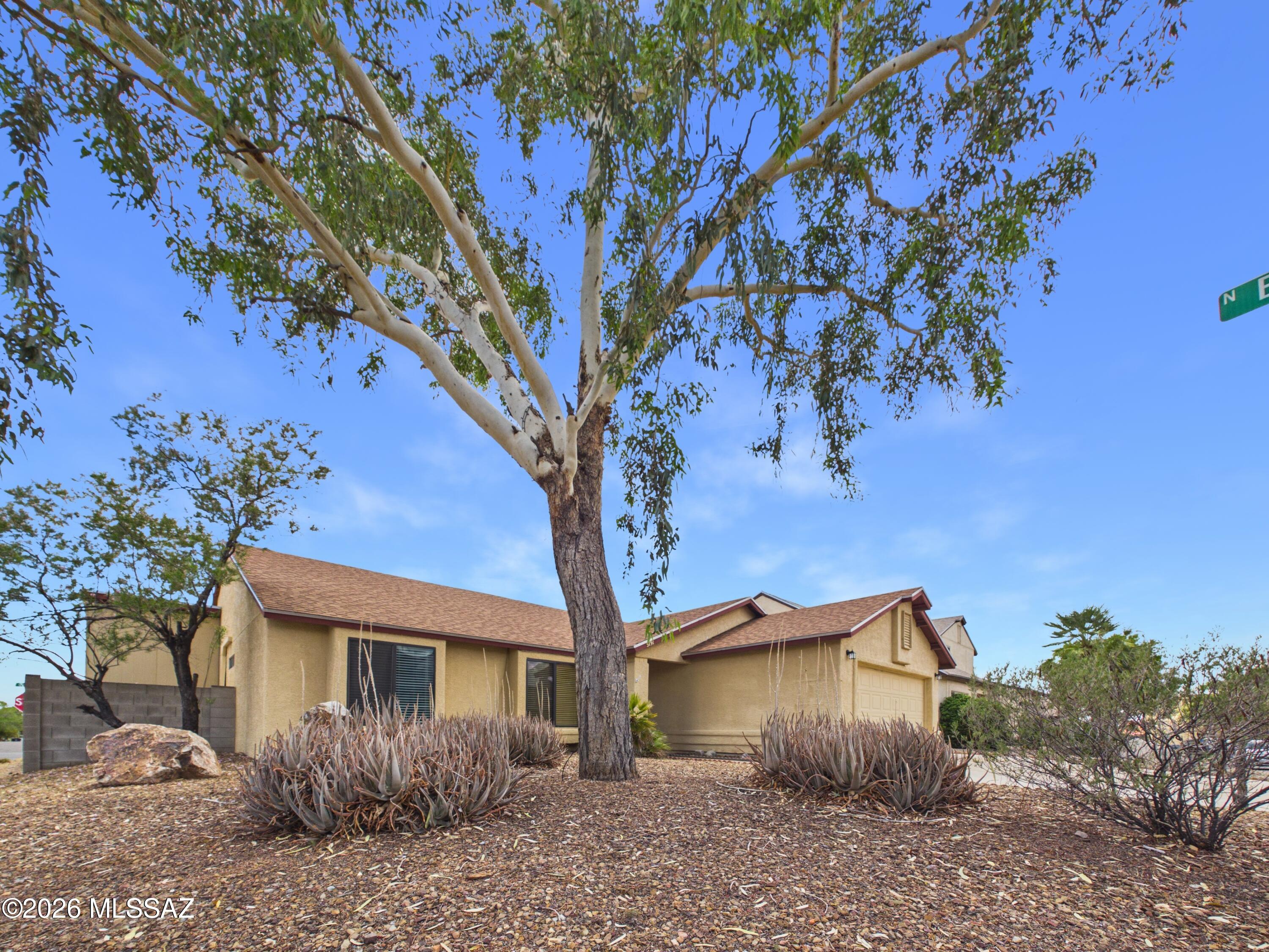 Well-maintained 3-bedroom, 2-bath home featuring a spacious, functional layout with a formal living room and an open family room with a cozy fireplace that flows seamlessly into the kitchen with breakfast bar. A bright Arizona room provides additional space for relaxing or entertaining. Interior highlights include tile flooring in main areas, wood flooring in secondary bedrooms, and carpet in the primary suite. The primary suite offers a private bath with a separate shower. High display ledges add architectural character. The garage features built-in shelving, and the backyard includes a large shed with ample shelving and storage space.