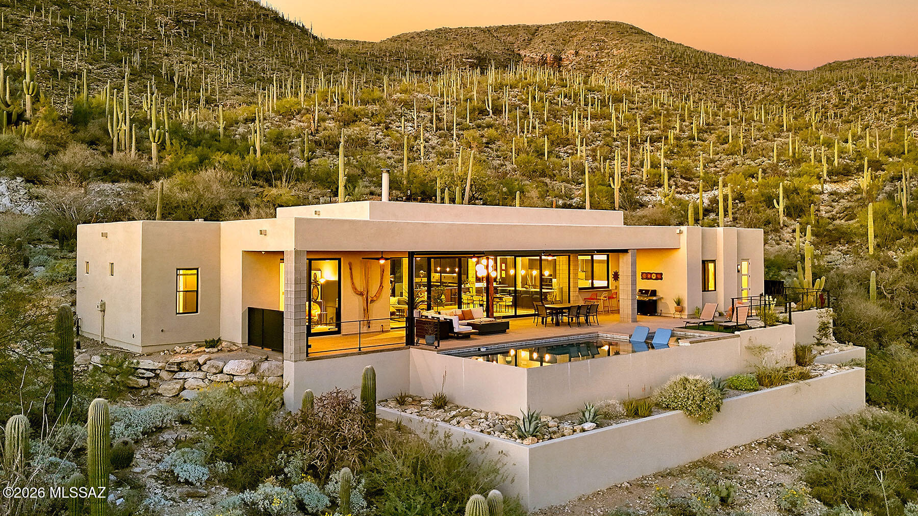 Magnificent Contemporary Masterpiece overlooking breathtaking city, mountain, & the signature 11th hole of prestigious guard gated Arizona National Golf Course. 
From the moment you enter, the 35 feet of walls of 9 ft. high sliding doors creates an atmosphere of Arizona indoor/outdoor living. This exceptional home custom built by Hartman Construction in 2023 with over 2959 sq. ft. encompasses a stunning Great Room with an Ergofocus suspended dramatic fireplace, 12ft. High ceilings, dining area with a custom Hennepin $9,000 light fixture, gourmet island kitchen with natural stone quartzite Mont Blanc countertops, custom cabinetry, GE Cafe induction cooktop, Miele standard oven, Miele steam/convection oven, Bosch refrigerator, GE Profile wine cooler, extensive breakfast bar...... .....gorgeous 2' x 4' tile floors, 3 bedrooms (split plan) & 3 full baths with primary bath featuring quartz countertops, double headed shower, large walk in closet, plus incredible office, laundry room with LG thinQ washer & dryer with steam cycle. Special features include 2 zoned Air conditioners, 2 gas furnaces, 2 hot water heaters, reverse osmosis, 5 zoned sound system, swivel recessed lighting for ambiance & art work, 3 sets of electric blinds, LeGrand upgraded switches, in-floor outlets, security system with video cameras, 400 amp electric panel & dedicated electric car charger in the 3 car garage  Enjoy the resort like backyard complete with extensive covered patio, gas heated infinity pool by Cimarron Construction, app for controlling remote settings, gas fireplace, artificial turf, custom stainless steel cording fencing, serene setting with thousands of saguaros in the area and views, views, views!!!!