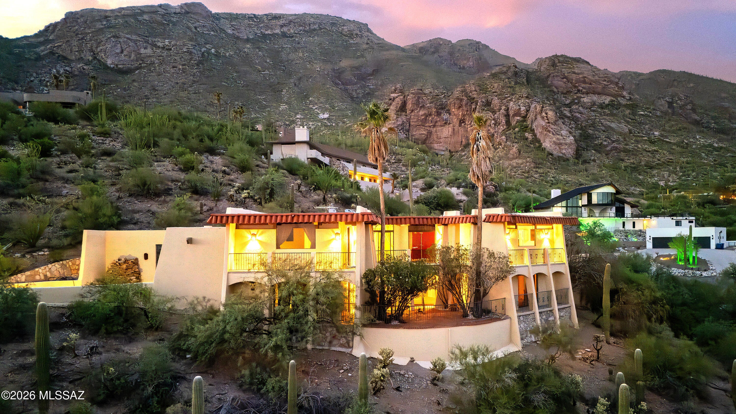 Perched high on the Catalina mountainside in prestigious, guard-gated Skyline Country Club Estates, this distinctive 3,726 sq. ft. masonry-stucco residence captures breathtaking panoramic views of Tucson, surrounding mountain ranges, and dramatic sunsets. Nestled into the hillside and surrounded by mature desert vegetation, the home offers a rare sense of privacy and tranquility while remaining close to everything Tucson has to offer.  Built by acclaimed Tucson master builder Howard Curtin, who built exactly 100 homes before retiring, this unique residence reflects the craftsmanship and character for which his homes are known. Rough-sawn and rough-hewn beams, multiple fireplaces and inviting Southwestern architecture create a warm, retreat-like atmosphere throughout. The home features 4 bedrooms, 2 full baths and 2 half baths. An expansive living room with fireplace and rough-sawn beams flows into a comfortable den featuring the same architectural character. The remarkable 23' x 15' Arizona room is filled with built-ins and rough-hewn beams, creating an exceptional space for entertaining, relaxing or taking in the surrounding scenery.  Outdoor living is equally inviting. A charming back patio with pool and fireplace provides an ideal setting for quiet evenings or entertaining beneath Tucson's legendary sunsets. Additional walkways and patios create intimate spaces for enjoying the natural desert landscape.  This special property is a blank canvas awaiting your vision, designer touches and dream finishes. Its exceptional construction, distinctive architecture and extraordinary setting offer an exciting opportunity to transform this one-of-a-kind residence into your own private Tucson masterpiece.  A rare combination of privacy, views, craftsmanship and location, this Skyline Country Club Estates retreat offers the opportunity to own a piece of Tucson architectural history, with golf, tennis and pickleball at your fingertips