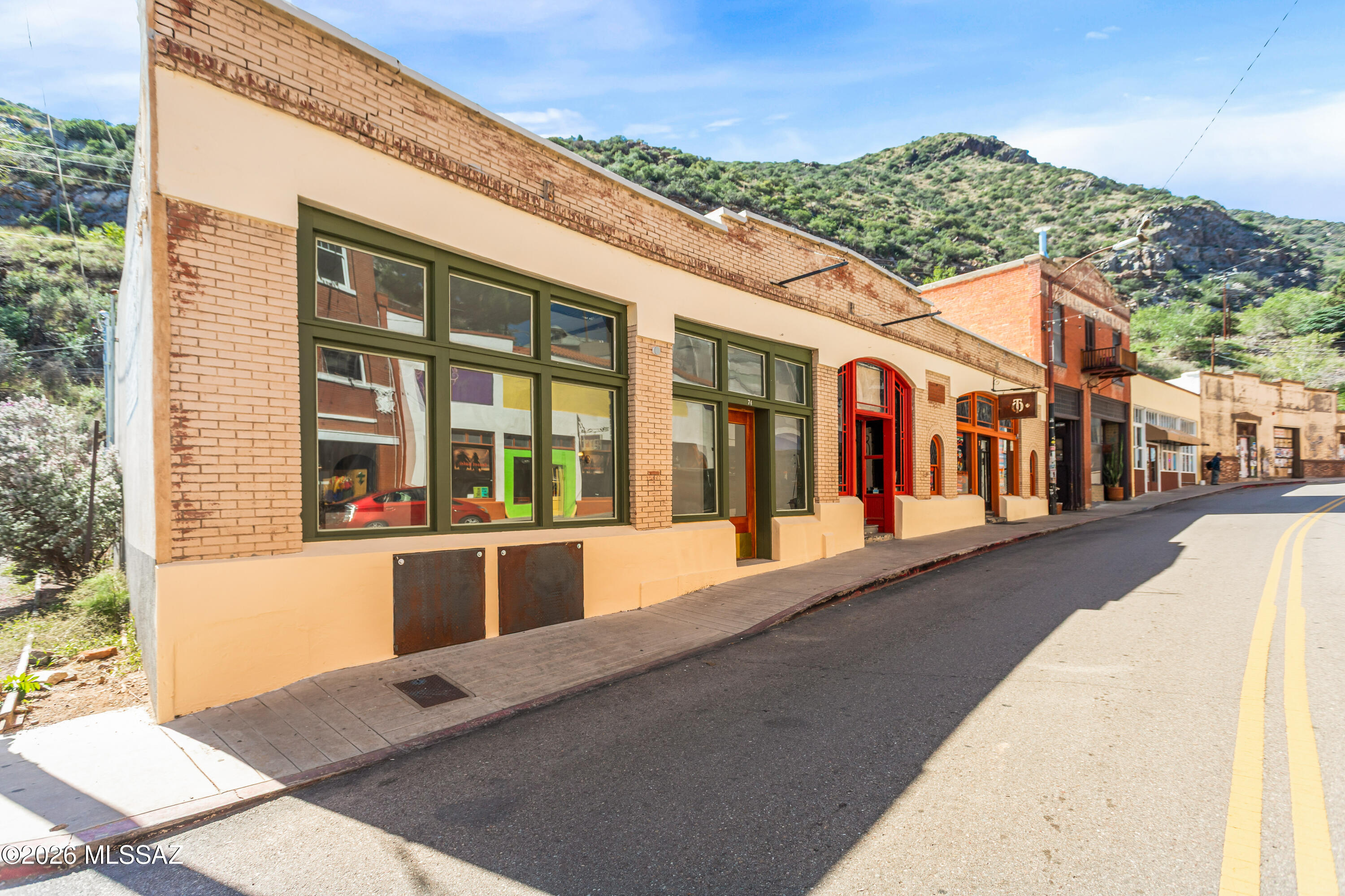 Prime Main Street investment opportunity in the heart of Bisbee within the highly sought-after Bisbee Historic District. This 3,586 sq ft historic commercial building (circa 1900) has been extensively renovated, blending preserved character with substantial modern infrastructure upgrades. Currently configured as three restaurant spaces under one roof. Two spaces are leased to established operators (Taqueria Outlaw and Santos speakeasy), with one large nearly turnkey space available. Flexible potential: vacant space may be converted to residential use offering live/work or mixed-use opportunity. The vacant space includes a 10-ft Type 1 hood with fire suppression, walk-in refrigerator (new cooling system), commercial high heat dishwasher, deck oven, grease trap system, upgraded plumbing and electrical, 200A service, dedicated circuits, new PEX main water line, dual 4-inch PVC waste lines, floor drains throughout, and 3- & 5-ton HVAC units. Custom tile, white oak floors, skylight, bar infrastructure (with water, power, and draft system capability), and quality finishes complete the space. Adjacent to one of the largest free public parking lots in town with strong foot traffic and visibility. Current cap rate 2.12% at 2/3 occupancy. Projected 6.34% at full occupancy (NOI $63,081). A rare opportunity to acquire a historic hospitality asset with modern infrastructure in one of Southern Arizona's most distinctive tourism markets.