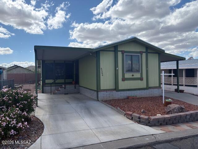 Nice split 2 bedroom 2 bath home with carports on both sides and rear deck for sunset viewing. Newer water heater and HVAC. Roof replaced about 6 years ago. Stacked washer dryer off kitchen. Screened porch behind kitchen and off primary bedroom. Security screen doors included. Ceiling fans and skylights. Whole house water filter system. Located in an active 55+ community, the HOA fee includes exercise facilities, shuffleboard, pool, spa, and rec center. Best of all--you own the land. This is carefree living at its finest.