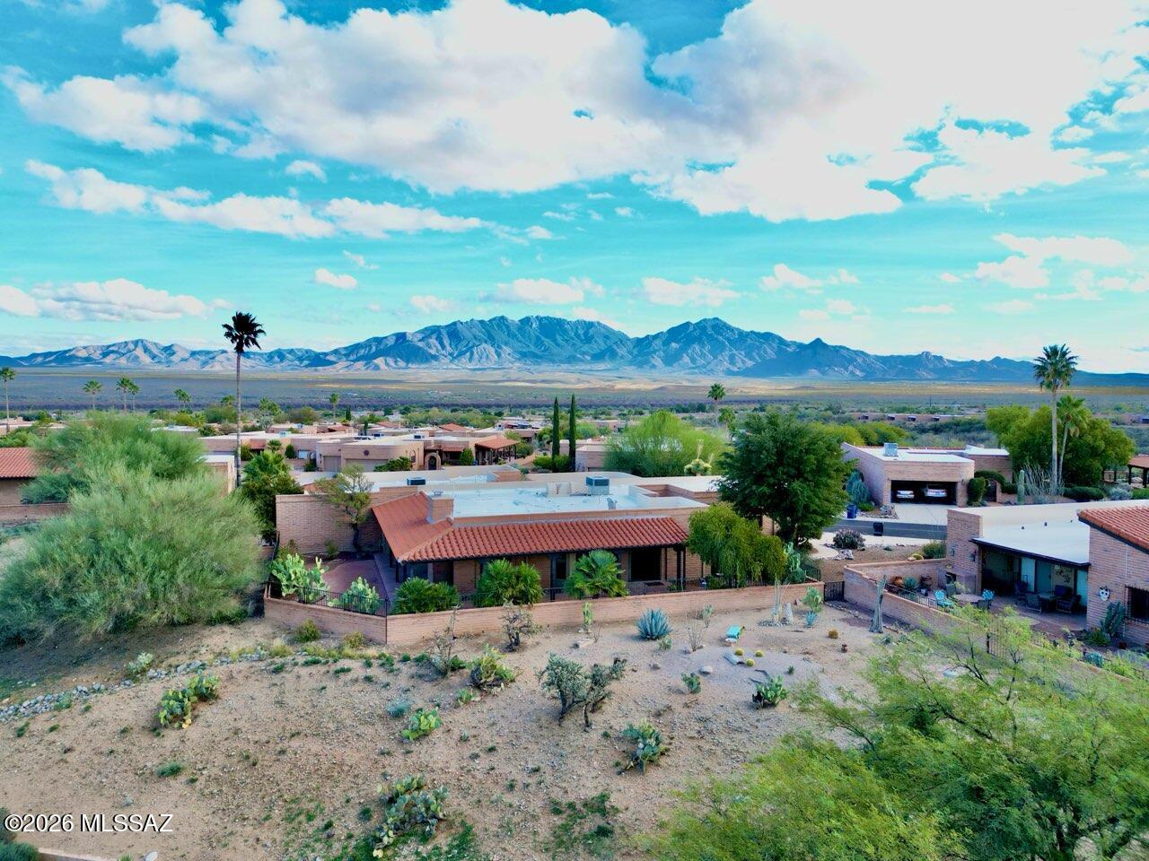 This beautifully remodeled 3-bedroom end-unit townhome offers a bright, open great room with granite breakfast bar, wet bar & gas fireplace. Saltillo tile floors, maple cabinetry, granite counters, abundant windows & skylights fill the home with natural light. Enjoy a wrap-around covered patio backing to common area with Catalina Mountain views, plus remote-controlled shades for sun control. Both bathrooms were fully updated in 2022 with executive-height soft-close maple vanities with pull outs, granite tops, a heated Bask Kohler tub in guest bath & a spacious walk-in shower in primary. The primary suite includes a tucked-away office/craft nook with built-ins. Quiet, private setting close to Canoa Hills Trail, Canoa Rec Center, and nearby golf—ideal for comfortable, low-maintenance livin