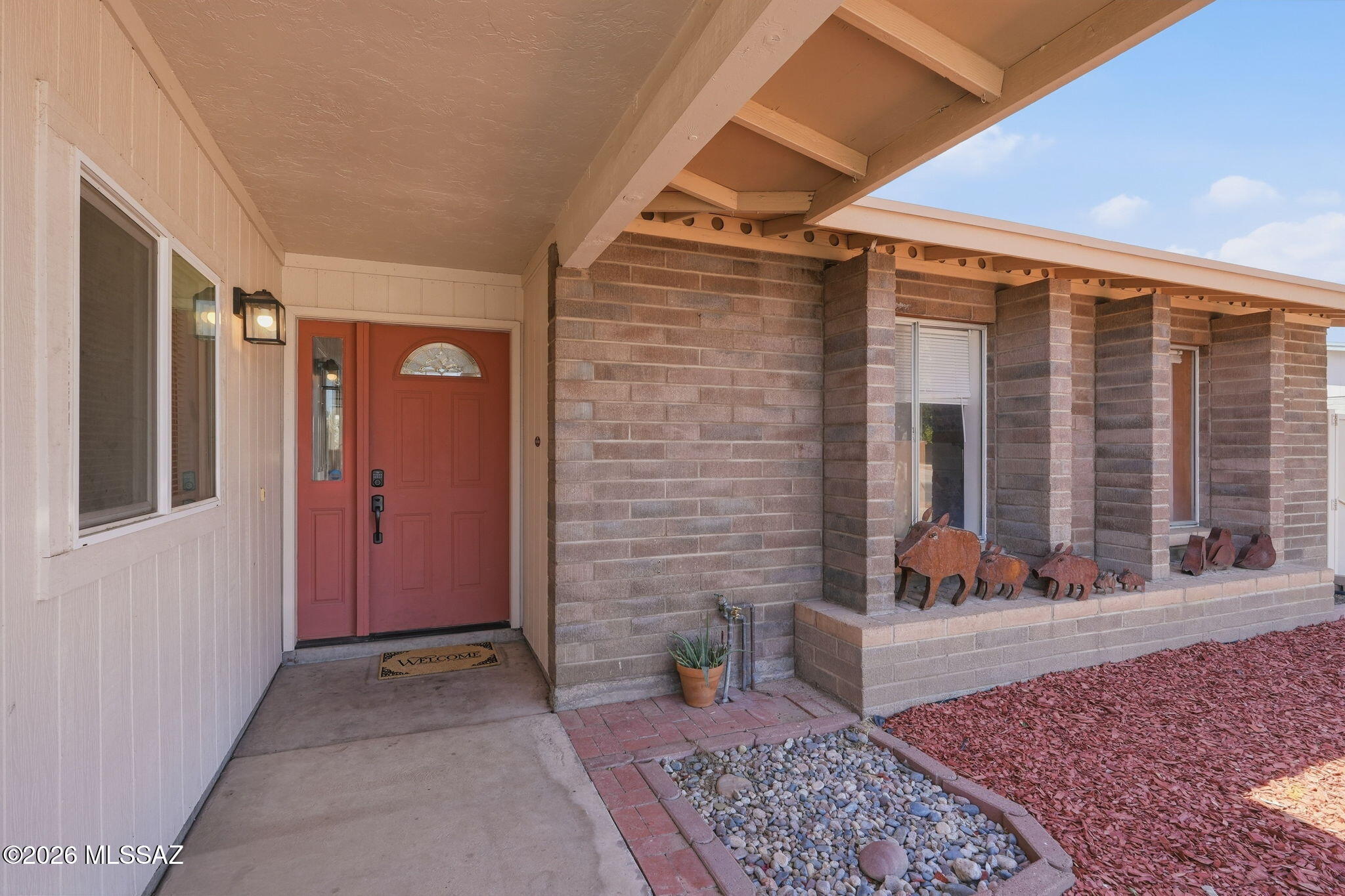 Located just minutes from the freeway, this charming ranch-style home offers both convenience and character. Fresh interior paint pairs beautifully with rich wood flooring, while hickory cabinets add a warm, upscale touch to the kitchen. This home is packed with extras, including a converted garage featuring a spacious 12x20 bonus room plus a 10x13 workshop/storage area complete with a sink, perfect for hobbies, projects, or additional living space. Step outside to a covered back patio overlooking a quaint pool, ideal for cooling off on warm desert days.
The property also boasts large dual wrought iron entry gates to the side yard, providing ample space for all your toys, an RV, or even a company vehicle. Located within walking distance to Richardson Park, come see today!