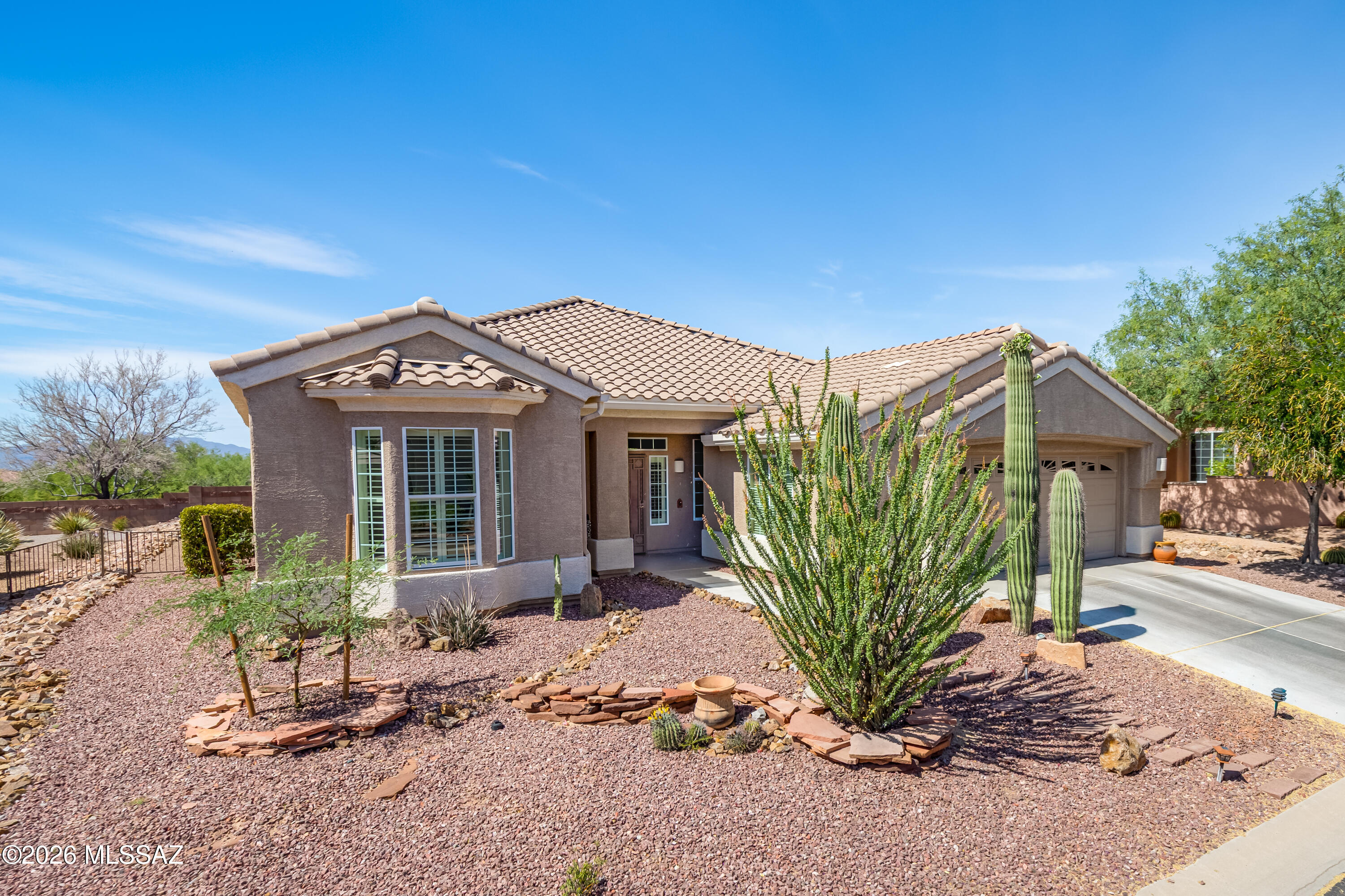 Experience refined desert living in this beautifully maintained Santa Rosa floor plan home, ideally located near the south gate of the highly sought-after Highlands at Dove Mountain, a premier 55+ gated community. Offering over 2,000 square feet, this popular and thoughtfully designed residence features 2 bedrooms, 2 baths, plus a versatile office/den--perfect for guests, hobbies, or working from home.
The home showcases a spacious, open layout with a great room concept and a dining area seamlessly integrated into the kitchen, creating an ideal setting for both everyday living and entertaining. Tile flooring runs throughout, with carpet in the bedrooms only, offering both style and comfort. The well-appointed kitchen serves as the heart of the home, complete with a gas range, built-in microwave, dishwasher, refrigerator, and a large island--perfect for gathering with family and friends.
Step outside to your private backyard retreat and take in sweeping views of the southern mountains and golf course. The large covered patio and extended outdoor living space provide the perfect backdrop for Arizona living, featuring a built-in BBQ grill, fire pit, and tranquil water feature--ideal for relaxing or entertaining under the desert sky.
Pride of ownership shines throughout--this home has had only one owner and has been meticulously cared for. Its prime location offers both convenience and a peaceful setting within the community.
Residents of The Highlands at Dove Mountain enjoy an exceptional lifestyle with access to an 18-hole golf course, a state-of-the-art recreation center, pickleball and tennis courts, and a resort-style pool and hot tub. The on-site restaurant adds to the experience, offering top-tier dining just moments from your doorstep.
This is more than a home--it's a lifestyle defined by comfort, views, and community.