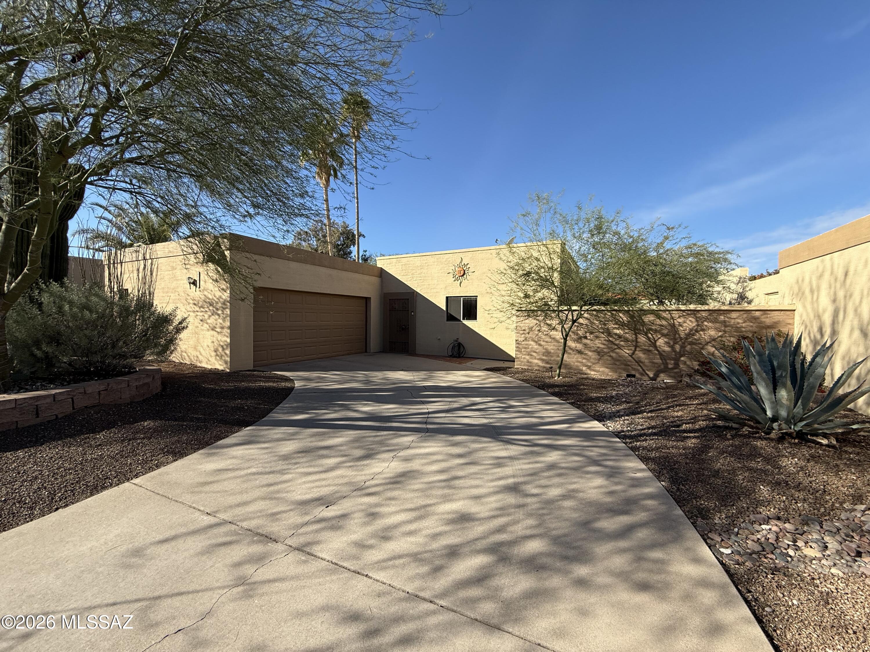 This charming 3-bedroom, 2-bathroom single-level home offers 1,401 square feet of comfortable living space in the desirable Fountain Park community. The galley-style kitchen features solid wood cabinets, tiled countertops, and a matching backsplash. The cozy living area includes a fireplace and a light-filled atrium that brings the outdoors inside. The primary bedroom offers a walk-in closet and an updated ensuite shower, while the additional bedrooms are well-sized and share a full hall bath. A bonus 98-square-foot Arizona room overlooks the beautifully landscaped, low-maintenance backyard, complete with an extended flagstone patio, raised planter beds, a shady mesquite tree, and a hot tub with slider access from the primary bedroom. The home includes a two-car garage with additional storage space. Community amenities include a pool, park, playground, and scenic walking paths--all within a peaceful, established neighborhood conveniently located near shopping, dining, and schools.