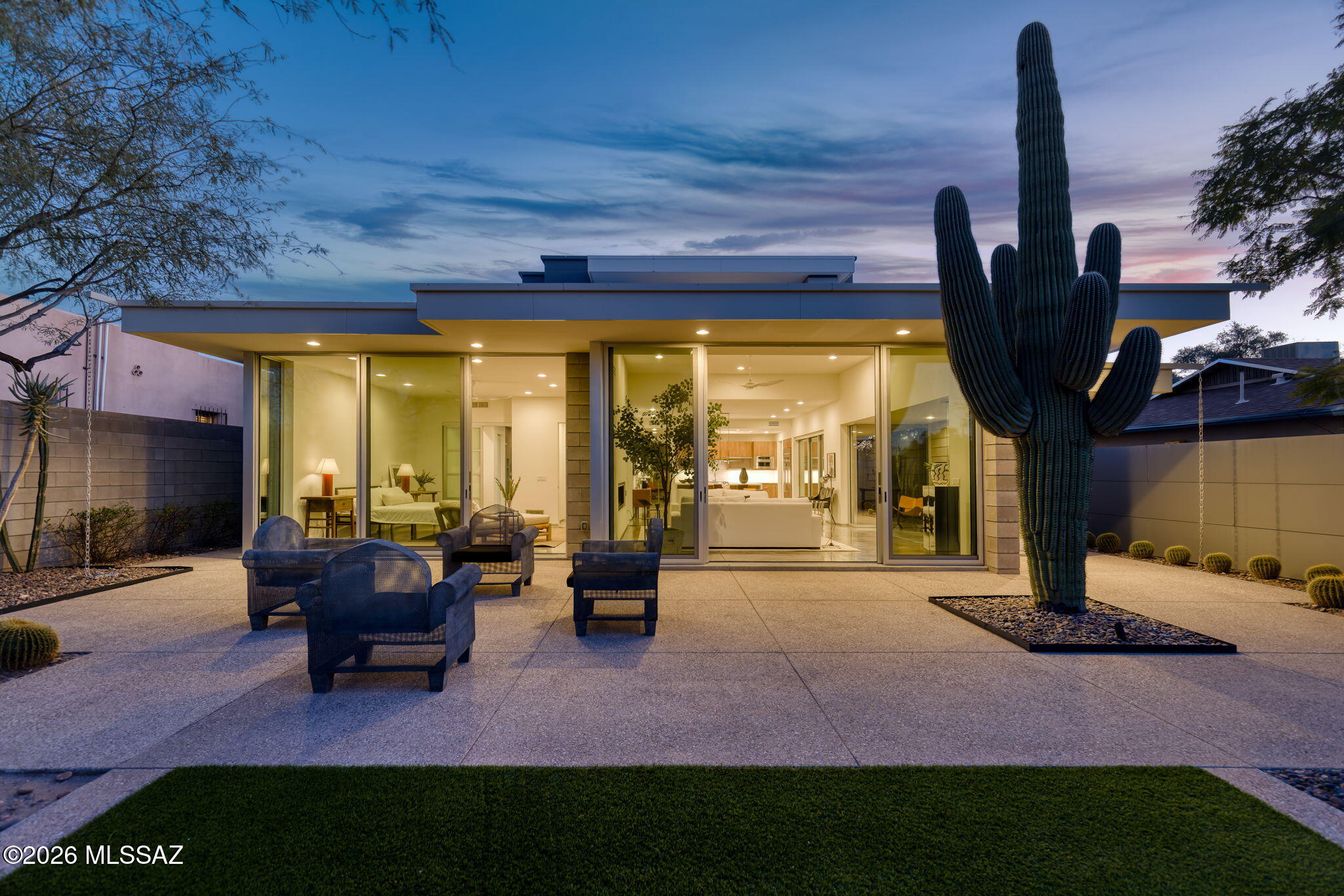 A rare modern offering in Sam Hughes, this architect-designed residence is defined by privacy, precision, and architectural clarity. Designed and built in 2017 by Donald Kornberg, the home reflects a distinctly modern architectural expression with clean lines, thoughtful scale, and seamless indoor-outdoor living.

Spanning 3,183 square feet, the flexible floor plan is anchored by a light-filled great room featuring an electric linear fireplace and expansive Western Windows. Three distinct outdoor courtyards—north, east, and west—are thoughtfully integrated throughout the home and framed by spectacular desert landscaping and mature cacti, creating natural light, privacy, and inviting spaces for entertaining or quiet retreat. A private roof deck adds an elevated layer of outdoor living.

The kitchen balances form and function with custom walnut finish cabinetry, quartz countertops, top-tier appliances with gas cooking, and a butler's pantry with wine refrigeration and laundry. The primary suite on the main level provides comfort and privacy, while additional bedrooms offer versatility for home offices, studios, or fitness spaces.

A rarely available three-car garage in Sam Hughes and total perimeter privacy complete this exceptional offeringan uncompromising modern residence in one of Tucson's most sought-after historic neighborhoods.