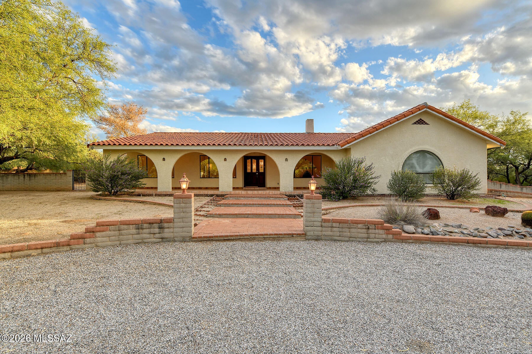 Charming Tanque Verde Valley home offering abundant space and the relaxed feel of a rural lifestyle. An oversized circular driveway welcomes you to this inviting property, while the expansive front porch provides the perfect place to relax and enjoy beautiful Catalina Mountain views. Inside, the home offers a welcoming living room, comfortable family room, and a versatile bonus flex space, creating plenty of options for relaxing, entertaining or working from home. A double gate provides convenient access to the expansive, fully enclosed backyard, where there is ample room for additional parking, recreational use, gardening, a future casita, or whatever your vision may be. For added peace of mind, the home has been completely re-plumbed with PEX piping.