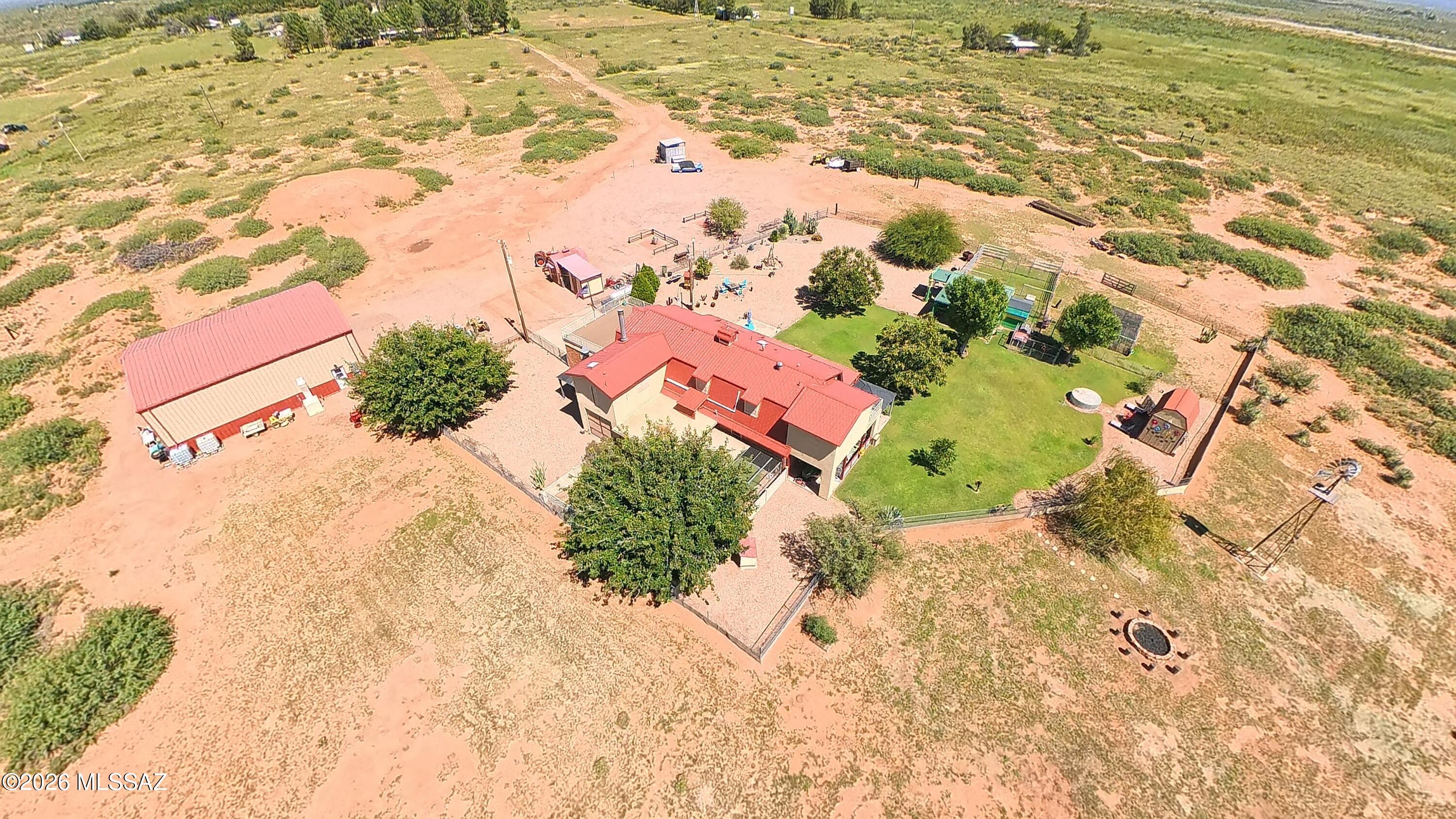 Discover a rare Arizona ranch retreat -CAR COLLECTORS DREAM-where wide-open desert skies meet refined ranch elegance on 20 pristine acres in McNeal. Centrally located just 15 mins from Bisbee, Douglas & Tombstone!!This stunning two-story farmhouse ranch is an entertainer's dream and a true turn-key treasure. Enjoy 360-degree views, mature fruit trees, lush green lawns on timed drip systems, and bordered to the south by acres of pecan orchard (not included with this property) that provides natural shade, lush greenery, PRIVACY and classic southwestern ambiance. With three full RV hookups, expansive outdoor living spaces, and a gourmet outdoor kitchen, this 3-bedroom, 2.5-bath beauty is ready for unforgettable gatherings or peaceful private living under unobstructed starlit skies. The 2,700 sq ft main home with 2 car garage is paired with an extraordinary 2,000 sq ft heated-and-cooled 9 space tandem garage/hangar (total 4,700+ sq ft of conditioned space). Built with thick 8-inch concrete and engineered for heavy loads, it easily accommodates up to nine cars, three large RVs, or even a small plane--and can be transformed into a full-size guesthouse or two-story apartment.

The home has brand-new & UPGRADED metal roof (2023), four high-efficiency mini-splits, solar window screens, and a new well pump deliver modern comfort and efficiency.

The grounds are absolutely pristine--not a rock or blade of grass out of place--with full snake fencing, a fully enclosed dog run, and abundant room for horses and animals.

Inside, pure sophistication awaits: a gourmet kitchen, enormous party-ready dining room, inviting family room, and a media/pool-table retreat that opens onto an enclosed patio where you can enjoy the quiet sounds of the desert. The upstairs split floor plan features three bedrooms, including an oversized primary suite with private stargazing deck, plus a hall bath with soaking tub. A convenient half-bath sits just off the kitchen on the main level.In the East Courtyard, a museum-quality indoor/outdoor workshop offers endless space for tractors, hobbies, and projects. Most furnishings can convey on a separate contract, making this elegant farmhouse ranch truly turn-key. Whether you seek a private desert sanctuary, a multi-generational estate, or a high-end entertaining property, this McNeal masterpiece delivers the ultimate blend of western freedom and refined living. Would make a perfect wedding destination or AirBnB/destination Inn, with the famous Whitewater Draw just a few miles away for birding guests.

***4th BEDROOM is also the media/pool table room downstairs, NO closet***

WELCOME HOME!!