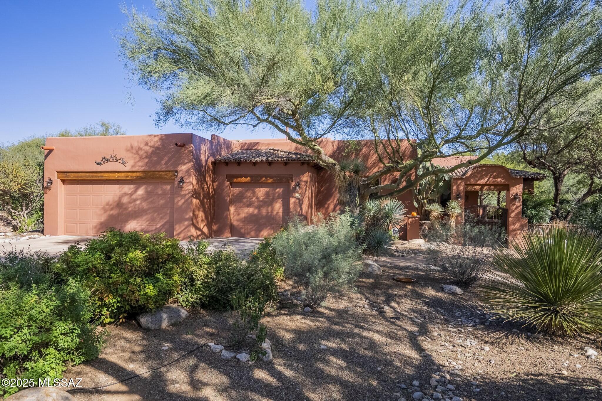 Welcome home to your Tubac sanctuary, on a large premier lot nestled off the beaten path and backing directly onto the scenic Anza Trail. Located in the desirable Santiago section of the Barrio, it offers a spacious layout with two bedrooms plus bonus space and a private outdoor oasis with shimmering pool. Enjoy al fresco entertaining in spaces framed by mature landscaping, offering a gentle transition into the trail corridor. Open-concept interior floorplan includes bonus room that's perfect for home office, art studio, or easily converted into a 3rd bedroom. Design details include rich millwork, warm tile flooring, kiva-style fireplace, plenty of natural light. Expansive primary suite features en suite bath with custom tilework. Landmark location offers easy access to galleries, shops, fine dining, yet tucked away for quiet and privacy.