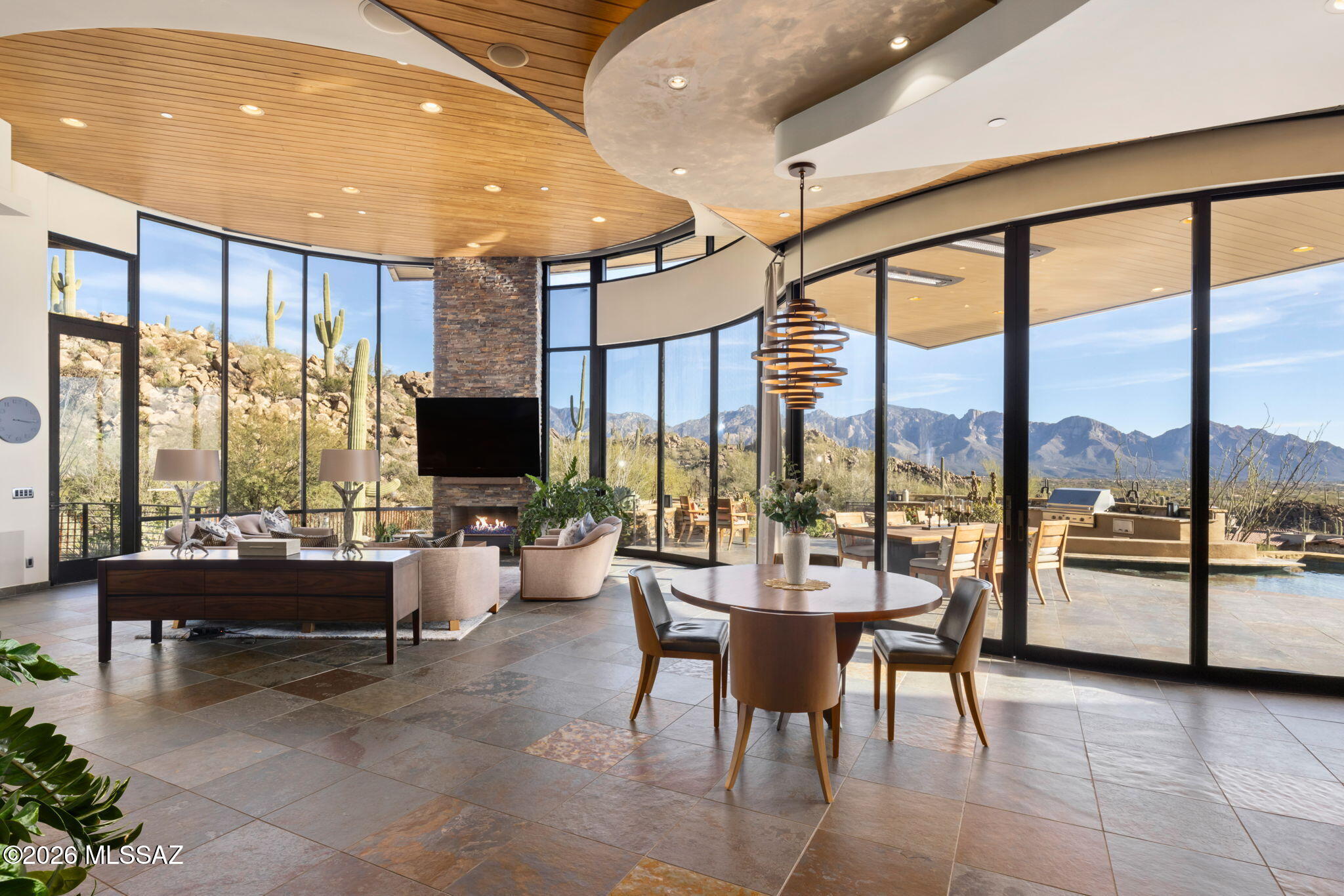 BREATHTAKING! Top of the World forever views of majestic Catalinas & Tucson city lights. Stunning Marc Soloway architecture, KS Classic build, and Lori Carroll impeccable interior design created a timeless contemporary set high in Stone Canyon's 1400-acre guard-gated exclusive golf community. Sold furnished, this striking 7,263 SF residence with unique materials offers 4 suites, 7 baths, amazing kitchen (Sub-Zero & Viking amenities: gas range, warming drawer, ref drawers, large hidden pantry with 2nd fridge), office, laundry, exercise, sep guest area (full kitchen, game/TV area, private patios), loft with 4th suite & rooftop putting green plus sink/potting station. Spectacular main patio: glass neg edge pool, spa, gas firepit & features, ceiling heaters, pool bath, Viking outdoor kitchen!
