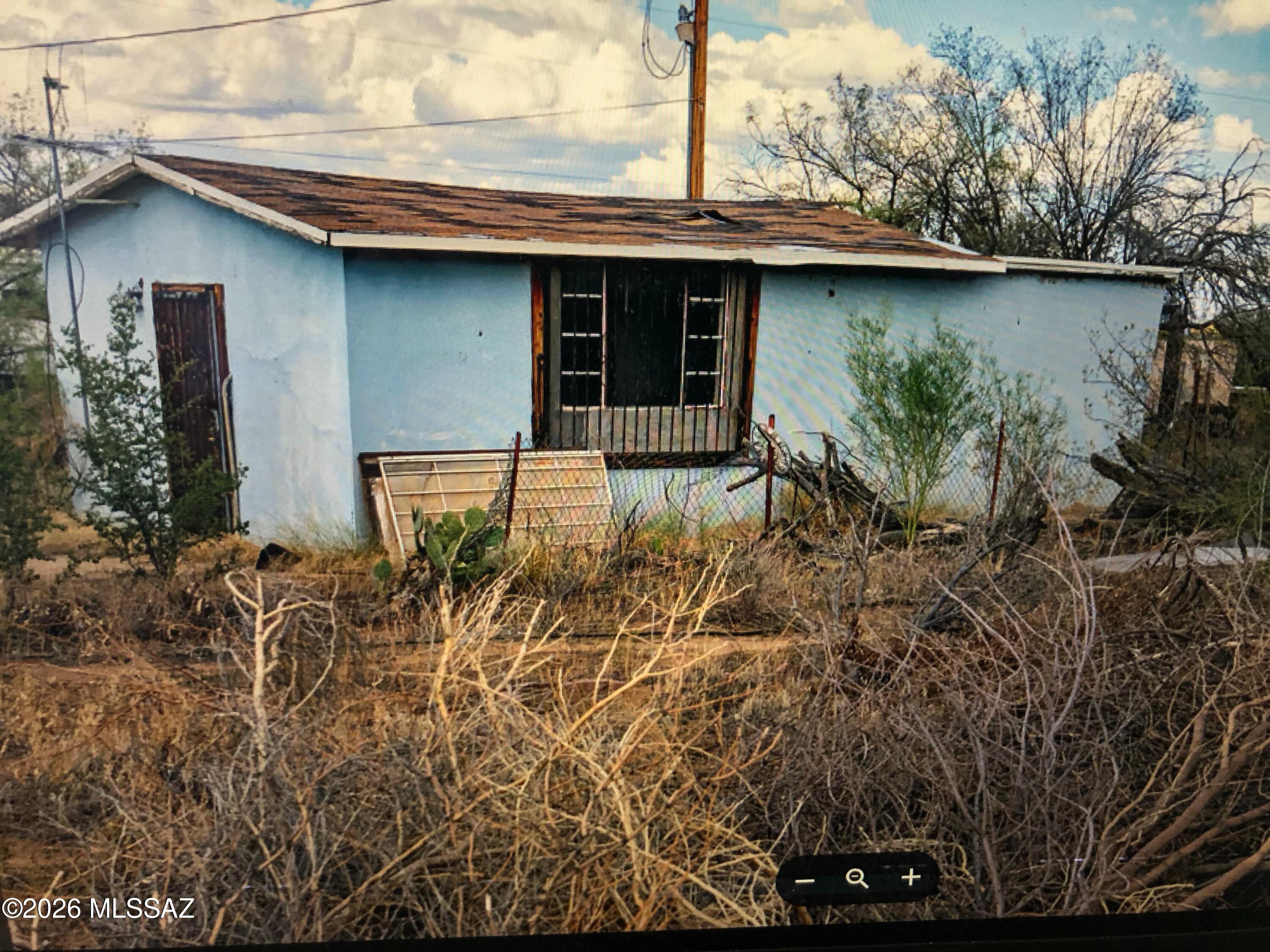 Exceptional, Lush Desert Homesite.  The opportunities are endless with this 0.97 acre lot! Originally Permitted with Pima County as a Travel Trailer Hookup.  Water, electricity and septic already installed. Septic tank needs repairs and will convert as/is without a septic certification. Fully fenced land with existing unpermitted buildings and permitted  ramada. Beautiful Hand Crafted Stone Chapel Structure. Pima County indicated that the current travel trailer permitting could be converted/renewed to allow installation of a Manufactured Home. Do your own due diligence regarding existing permitting.  Turn this into your own private paradise, toys and horses allowed! * Owner Agent **  No Deed Restrictions so you can use this property for anything you want consistent with the current zoning.