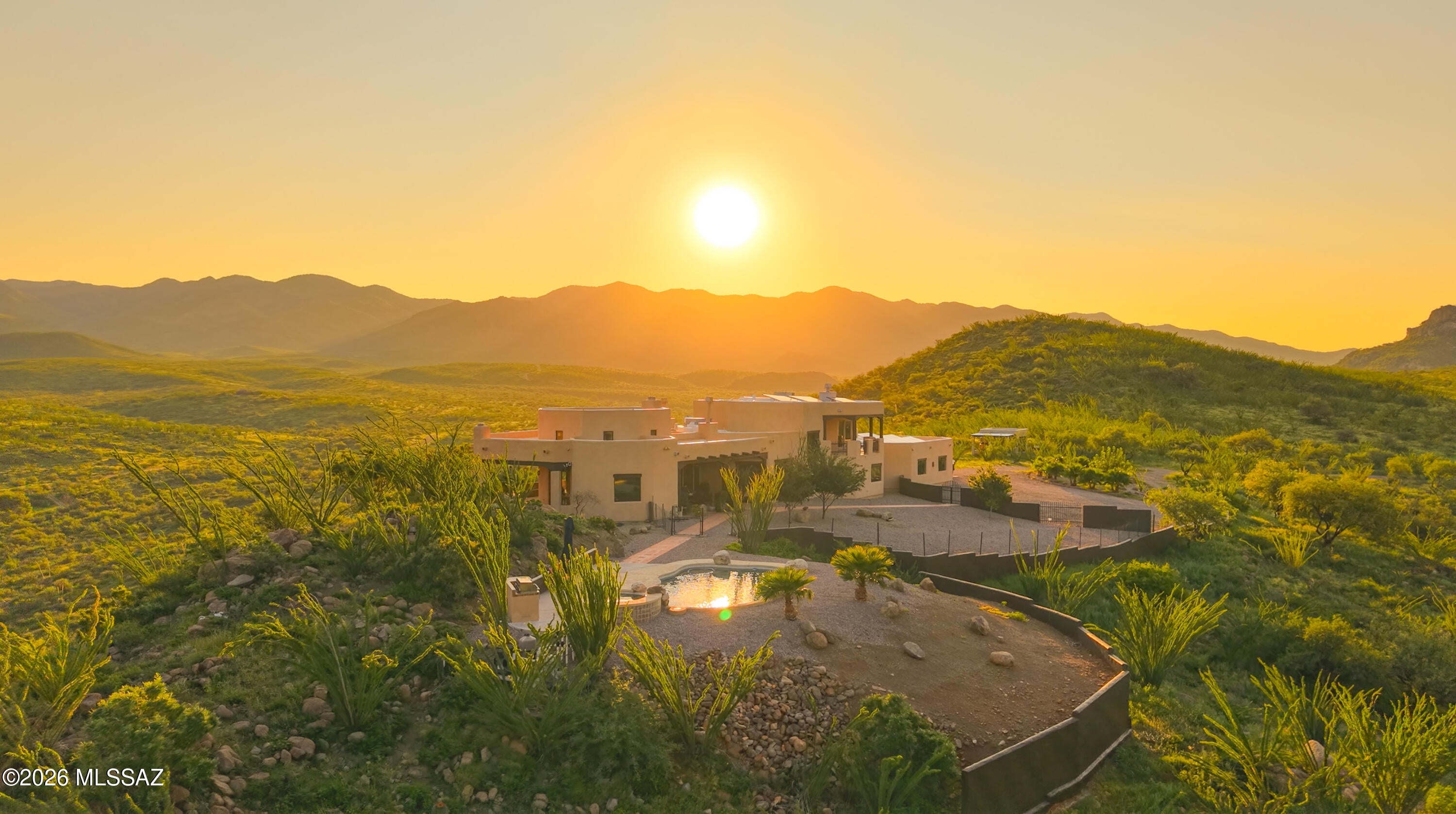 Some homes offer a beautiful view. This one gives you the entire horizon.

Perched above the untouched desert landscape of Salero Ranch, this extraordinary 77 acre estate feels less like a residence and more like a world of its own. From its elevated setting, approximately 4,700 square feet of authentic Southwestern architecture overlooks miles of rolling hills, rugged mountains, and open Arizona sky. The scale is impressive, but it is the feeling of the property, the stillness, freedom, and complete connection to the land that makes it unforgettable.

The home was designed to belong to its surroundings. Warm Saltillo tile runs beneath soaring ceilings, while massive wood vigas and rich tongue-and-groove details bring texture, craftsmanship, and unmistakable Southwestern character. At the heart of the home, a dramatic floor-to-ceiling stone fireplace anchors the great room, creating a space that feels both grand and intimate. Expansive windows transform the changing landscape into living artwork, allowing sunlight, mountain views, and desert colors to become part of the interior.

Step outside and the experience becomes even more captivating. Covered patios and elevated balconies provide front row seats to the natural beauty surrounding the home. Mornings begin quietly as sunlight moves across the mountains. Afternoons are made for relaxing beside the  pool and spa, surrounded by mature desert vegetation and remarkable privacy. As evening approaches, the entire landscape glows beneath the setting sun, creating an unforgettable backdrop for outdoor dinners, celebrations with friends, or a peaceful glass of wine.

After dark, the estate reveals another side of its beauty. Away from the distractions of everyday life, the night sky comes alive with brilliant stars, and the silence of the desert creates a sense of calm that cannot be manufactured or easily found. Here, stargazing can become a nightly ritual, sunsets are never taken for granted, and time seems to move at a gentler pace.

The six car garage offers exceptional capacity for a prized vehicle collection, recreational equipment, a workshop, creative pursuits, or the freedom to accommodate every passion without compromise. Beyond the residence, 77 acres provide an extraordinary canvas for exploration, recreation, and the creation of a lasting family retreat.

The greatest luxury offered here is not simply square footage it is space. Space to breathe, to gather, to disconnect, and to live surrounded by the wild beauty of Southern Arizona. Whether enjoyed as a full-time residence, private escape, or legacy estate for generations to come, this is a property that offers something increasingly rare: the freedom to live entirely on your own terms.

Some properties are admired. This one is felt.