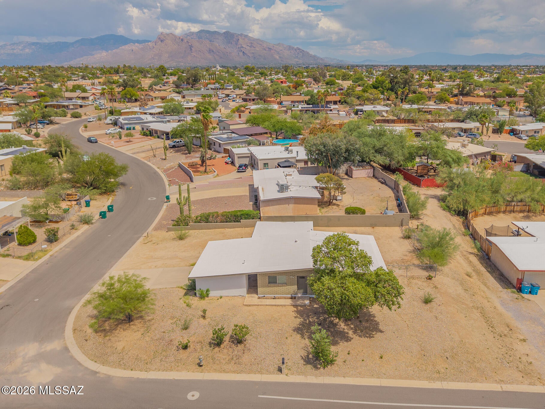 Charming North Tucson home offering comfort, space, and scenic surroundings. Step into a bright and welcoming living area in this 3 bedroom 2 bath residence featuring ceramic tile throughout for a clean and cohesive look. The open kitchen with updated hood vent flows seamlessly into the living room, creating an ideal space for everyday living and entertaining. Enjoy stunning Tucson mountain views from the elevated corner lot. The light filled interior opens to a huge covered patio, perfect for relaxing or hosting gatherings. A spacious lot and large two car carport add convenience, all with easy access to shopping, dining, and nearby amenities. Schedule a showing today.