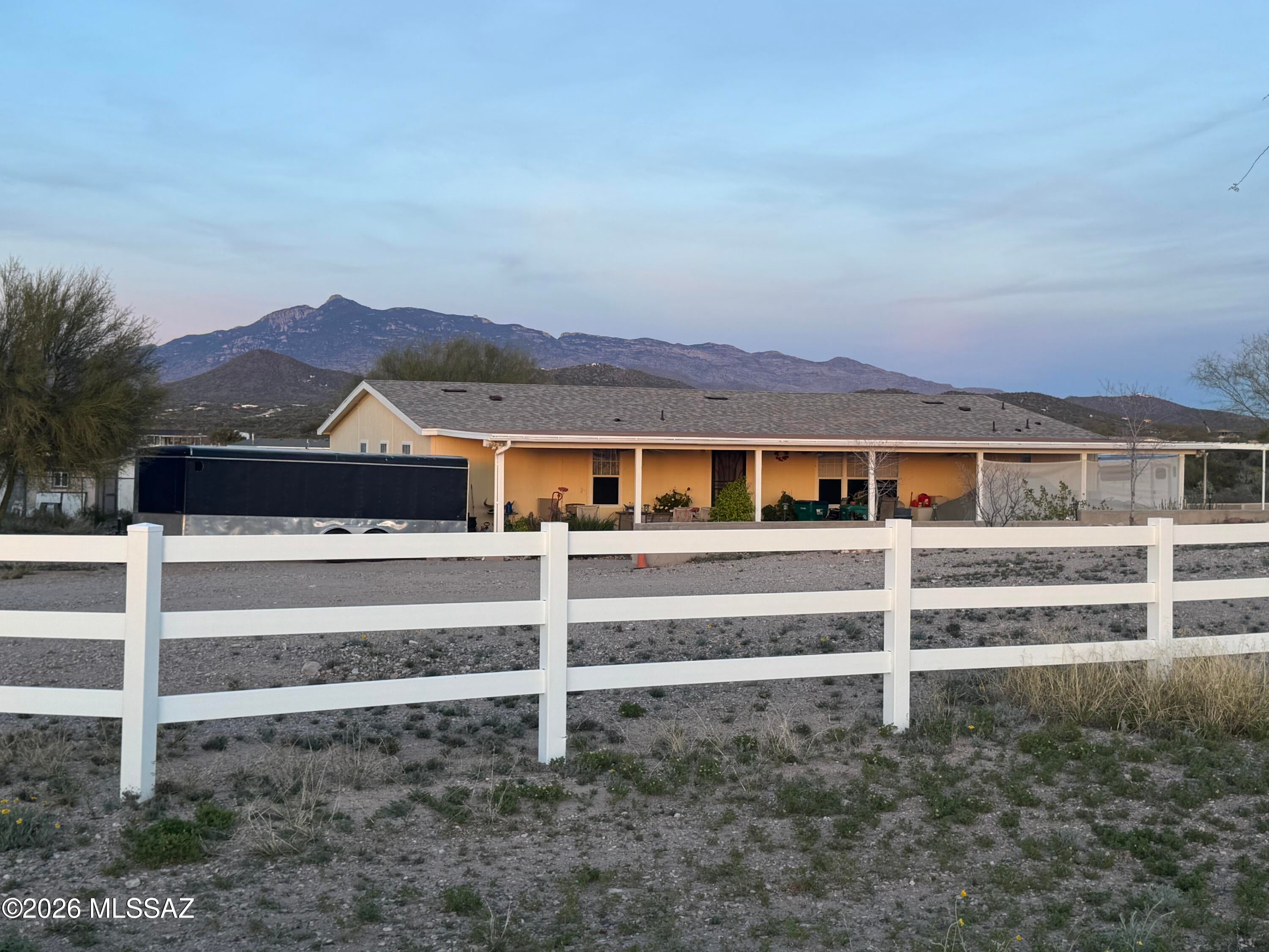 This beautiful 4-bedroom/2-bath house with a bonus room for an office is located on 1.46 Acres.  The 2006 Model has a brand-new roof and exterior paint.  HVAC is  2 years old.  The property is uniquely located, offering views of sunsets, sunrises, and mountains.  The porches were added to the front and back of the house to allow you plenty of room for outdoor enjoyment.  Property ideal for all your toys, cars, and RVs.   Conveniently located close to schools, shopping centers, and the interstate.