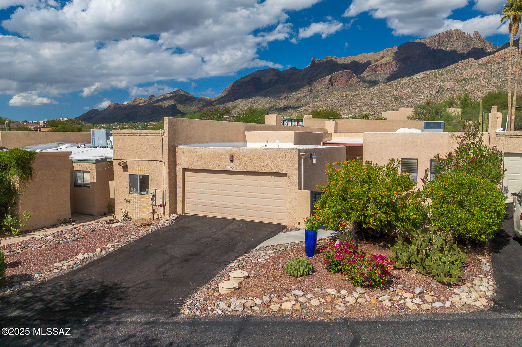 Experience privacy & mountain views in this move-in ready 3 bedroom, 2 bath townhome! A beautiful courtyard welcomes you w/ a custom art installation & beautiful vegetation. Inside, the living room offers incredible views of Finger Rock & the mountains. For those chilly winter nights, an attractive beehive fireplace adds to the ambiance. The adjacent dining room is great for hosting friends & family. An updated kitchen offers ample cabinet/pantry space, generous prep areas, & a reverse osmosis water system. The primary suite offers two closets, mountain views & an updated bath w/ walk-in shower & dual vanity. Relax or entertain on the expansive back patio under Tucson's starry skies. The friendly community offers a sparkling pool & walking trails. A perfect location w/ district 16 schools